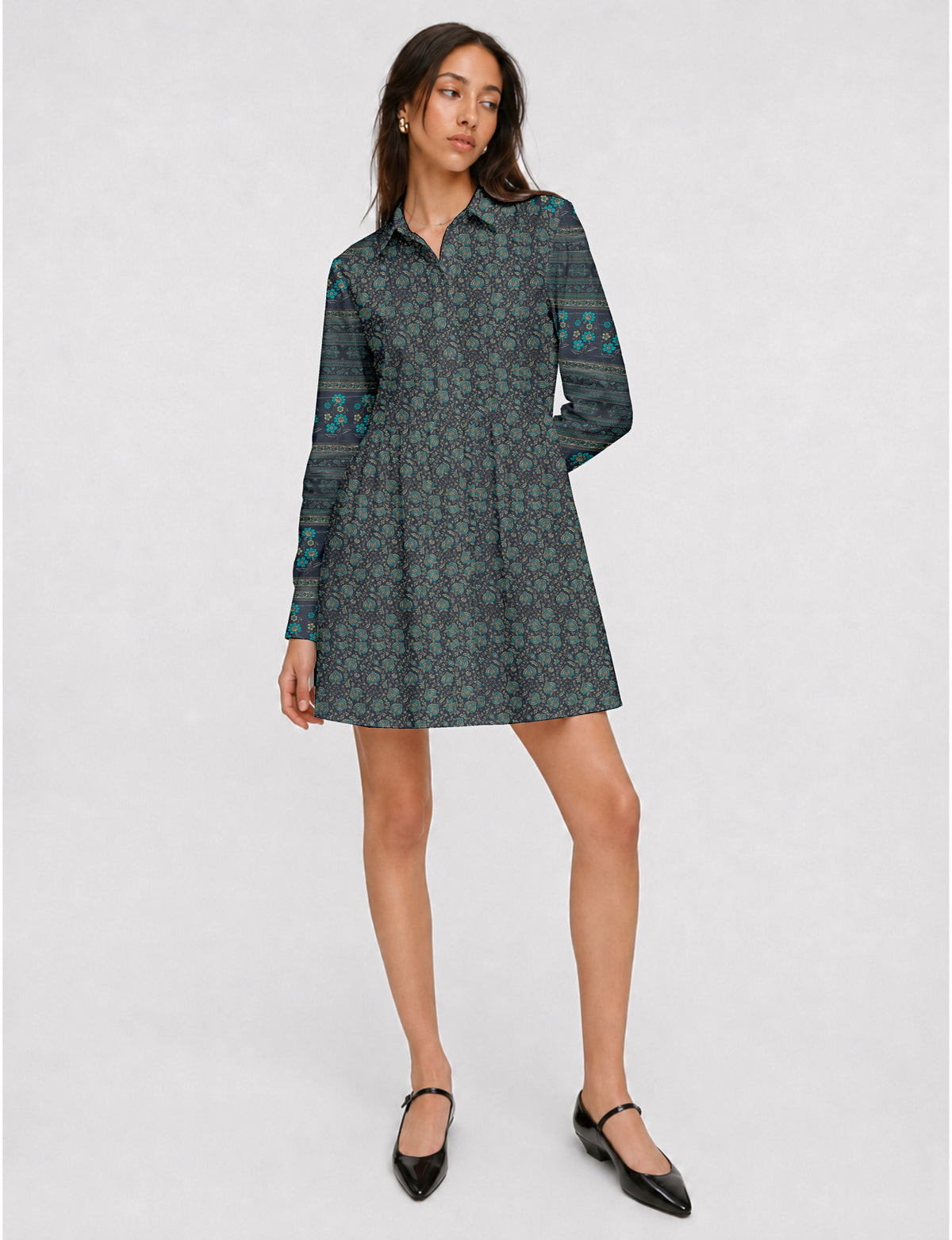 Short shirt dress with a relaxed A-line silhouette, point collar, partial button placket, gathered waist, side pockets, and full-length cuffed sleeves.