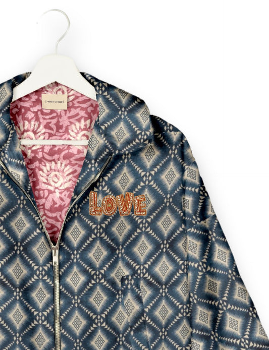 Love Bomber Jacket made from recycled fabric, featuring hand-stitched Aari embroidery. A unique piece of zero-waste clothing, part of the circular fashion movement. Designed with upcycled materials for a stylish yet environmentally friendly clothing choice.