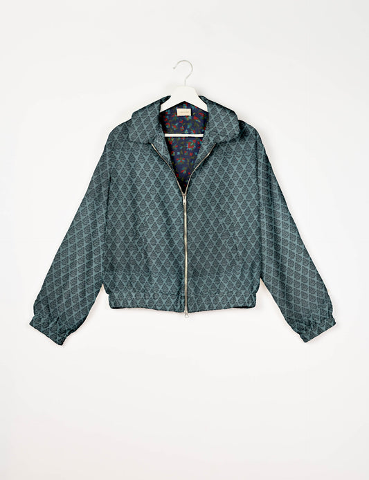 Upcycled Bomber Jacket made from recycled sari materials, featuring a cute cropped shape, elasticated hem and cuffs, and contrast sari print lining. Sustainable apparel promoting eco-friendly fashion and ethical clothing.