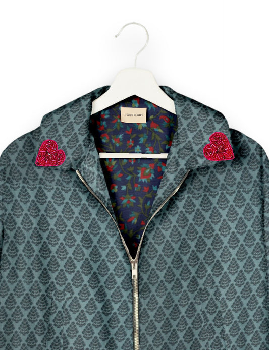 Make a bold statement with our Heart Drop Earrings, a symbol of conscious luxury and ethical fashion. Handcrafted using the intricate Aari embroidery technique, these earrings are made from upcycled sari fabric, embracing slow fashion and zero waste clothing. Elevate your look with sustainable apparel that supports fair trade fashion while reducing textile waste. Choose eco-friendly fashion that speaks of love, artistry, and responsibility.