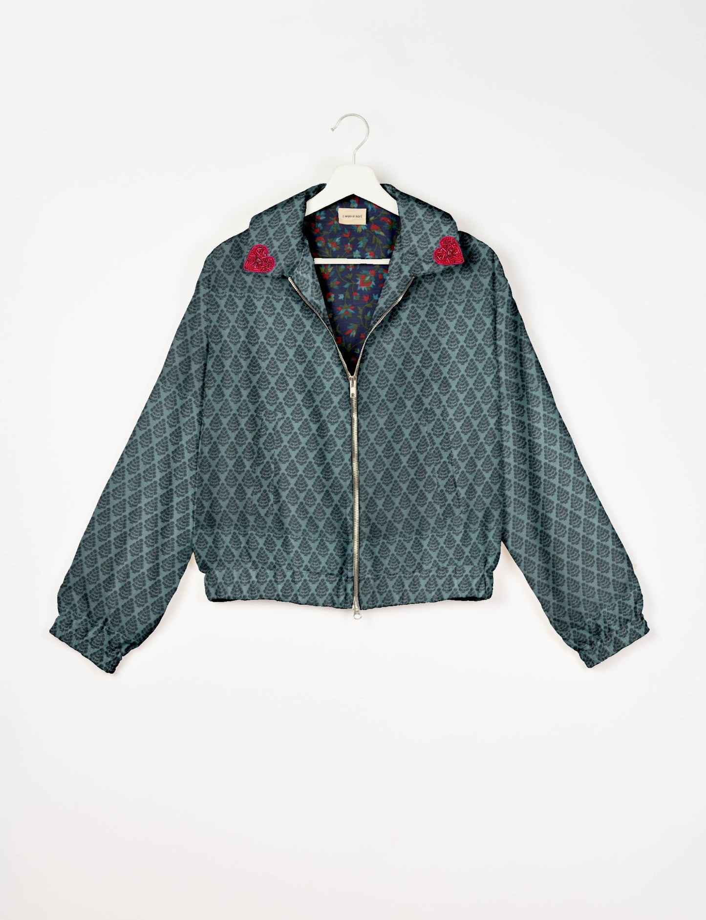 Make a bold statement with our Heart Drop Earrings, a symbol of conscious luxury and ethical fashion. Handcrafted using the intricate Aari embroidery technique, these earrings are made from upcycled sari fabric, embracing slow fashion and zero waste clothing. Elevate your look with sustainable apparel that supports fair trade fashion while reducing textile waste. Choose eco-friendly fashion that speaks of love, artistry, and responsibility.