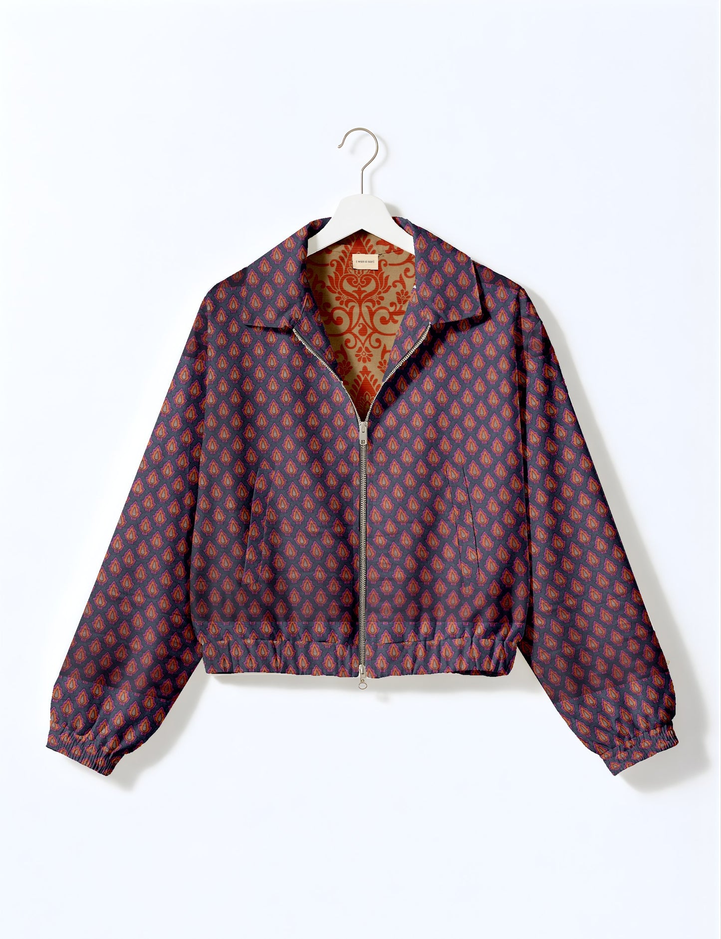 Upcycled Bomber Jacket made from recycled sari materials, featuring a cute cropped shape, elasticated hem and cuffs, and contrast sari print lining. Sustainable apparel promoting eco-friendly fashion and ethical clothing.