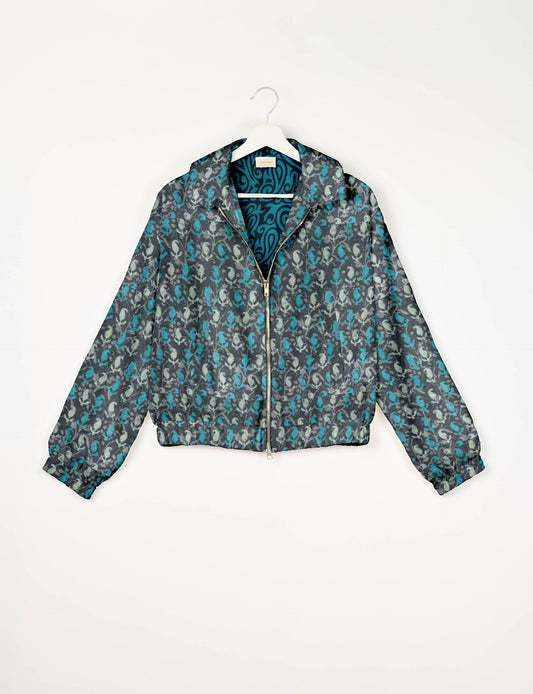 Upcycled Bomber Jacket made from recycled sari materials, featuring a cute cropped shape, elasticated hem and cuffs, and contrast sari print lining. Sustainable apparel promoting eco-friendly fashion and ethical clothing.