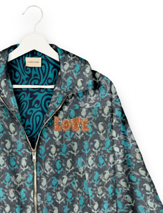 Love Bomber Jacket made from recycled fabric, featuring hand-stitched Aari embroidery. A unique piece of zero-waste clothing, part of the circular fashion movement. Designed with upcycled materials for a stylish yet environmentally friendly clothing choice.