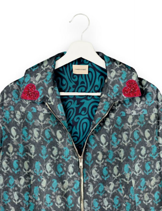 Make a bold statement with our Heart Drop Earrings, a symbol of conscious luxury and ethical fashion. Handcrafted using the intricate Aari embroidery technique, these earrings are made from upcycled sari fabric, embracing slow fashion and zero waste clothing. Elevate your look with sustainable apparel that supports fair trade fashion while reducing textile waste. Choose eco-friendly fashion that speaks of love, artistry, and responsibility.