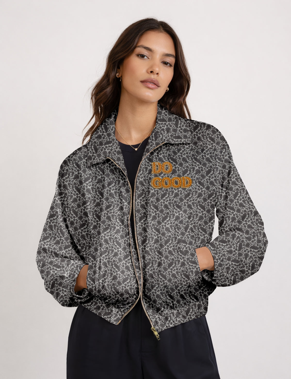 Gold cropped DO GOOD bomber jacket featuring hand-embroidered lettering on the left chest, contrasting inner lining and two functional pockets.