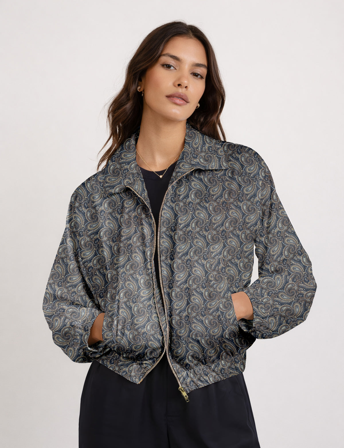 Woman wearing a yellow floral bomber jacket with front zipper, elastic cuffs, and side pockets, shown from front view