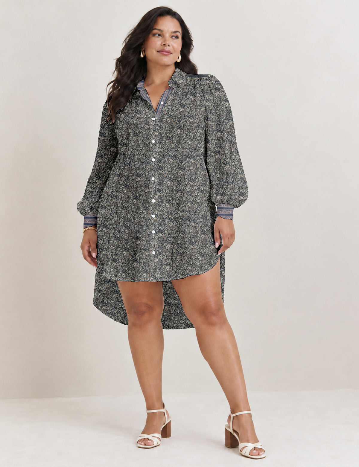 High low shirt with a relaxed fit, button-down front, classic collar, gathered shoulders and full-length blouson sleeves.