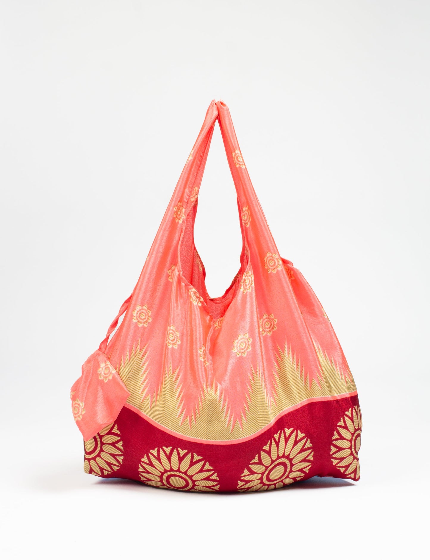 Stay eco-conscious with our Reusable Bag, handmade by Indian artisans from pre-loved saris. Silky and lightweight, this foldaway bag is perfect for your on-the-go lifestyle. Each piece is a unique statement of ethical fashion, embracing sustainability and style.