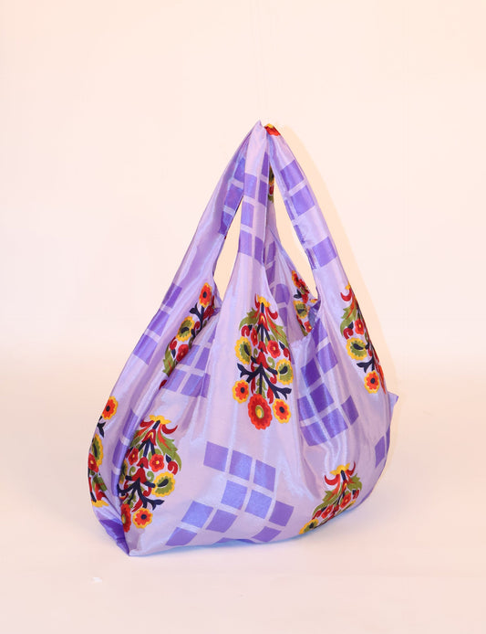 Stay eco-conscious with our Reusable Bag, handmade by Indian artisans from pre-loved saris. Silky and lightweight, this foldaway bag is perfect for your on-the-go lifestyle. Each piece is a unique statement of ethical fashion, embracing sustainability and style.