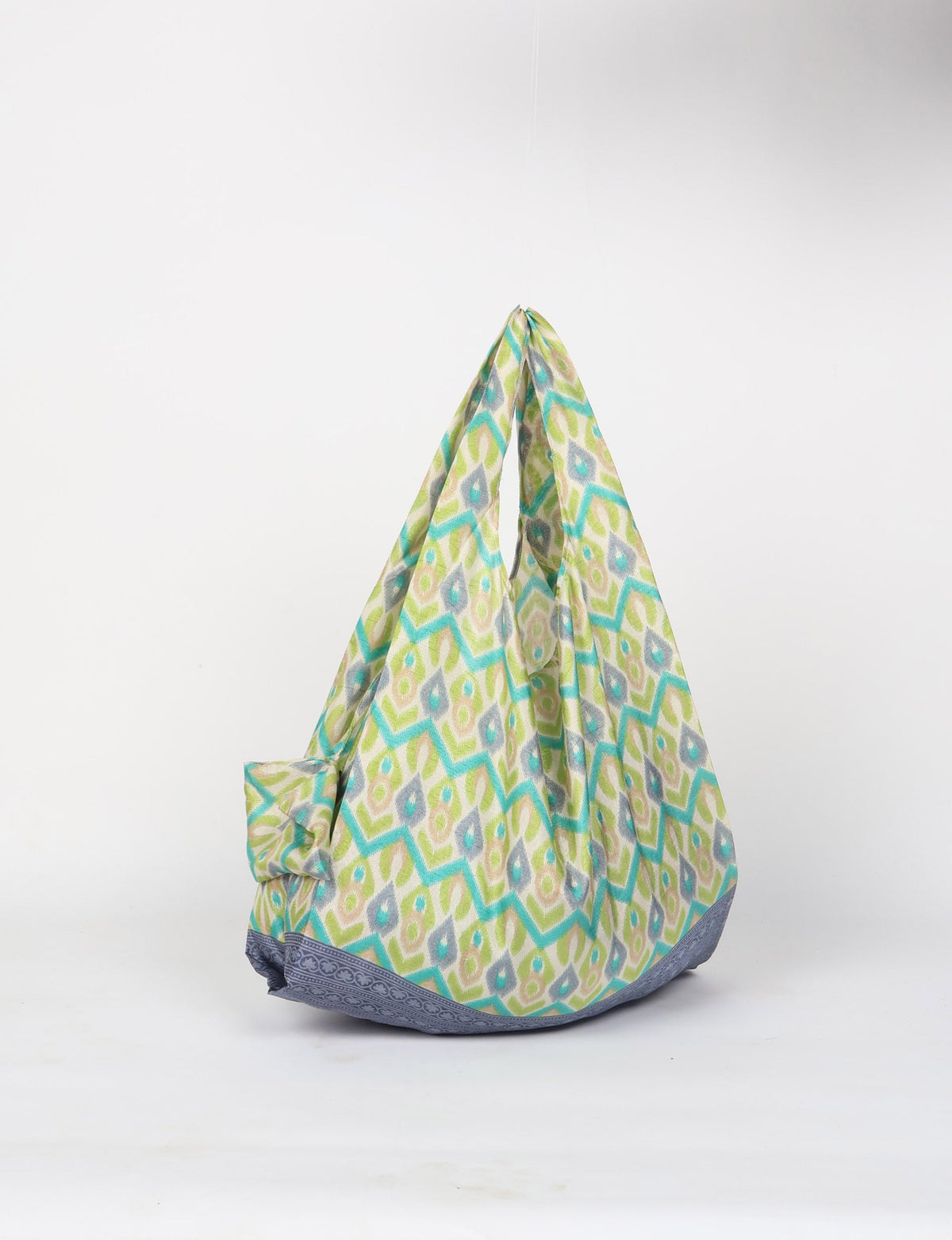 Stay eco-conscious with our Reusable Bag, handmade by Indian artisans from pre-loved saris. Silky and lightweight, this foldaway bag is perfect for your on-the-go lifestyle. Each piece is a unique statement of ethical fashion, embracing sustainability and style.