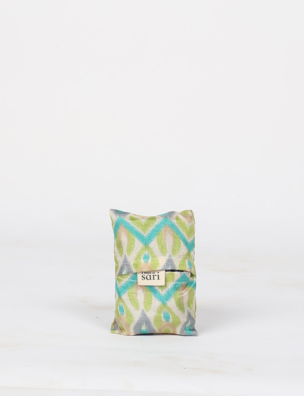 Stay eco-conscious with our Reusable Bag, handmade by Indian artisans from pre-loved saris. Silky and lightweight, this foldaway bag is perfect for your on-the-go lifestyle. Each piece is a unique statement of ethical fashion, embracing sustainability and style.