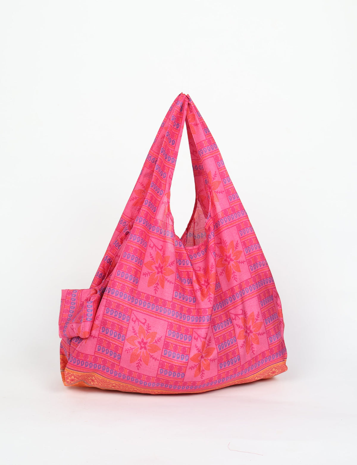 Stay eco-conscious with our Reusable Bag, handmade by Indian artisans from pre-loved saris. Silky and lightweight, this foldaway bag is perfect for your on-the-go lifestyle. Each piece is a unique statement of ethical fashion, embracing sustainability and style.