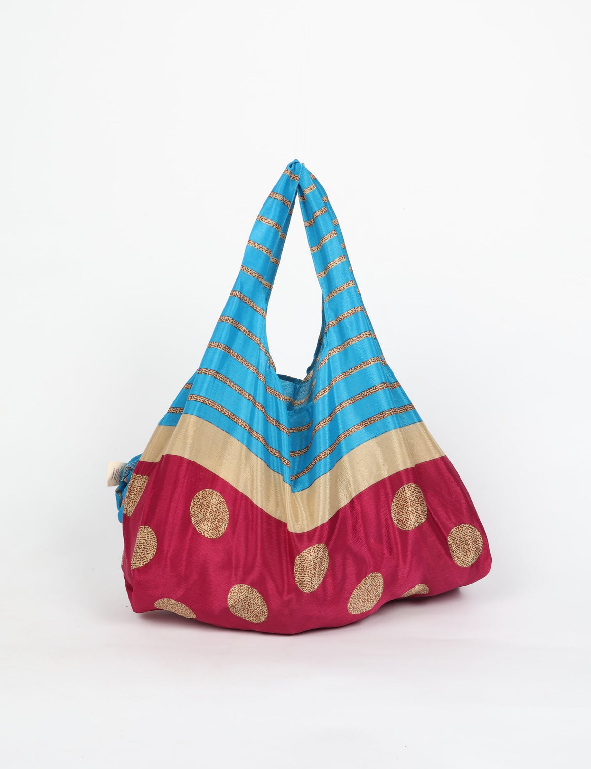 Stay eco-conscious with our Reusable Bag, handmade by Indian artisans from pre-loved saris. Silky and lightweight, this foldaway bag is perfect for your on-the-go lifestyle. Each piece is a unique statement of ethical fashion, embracing sustainability and style.