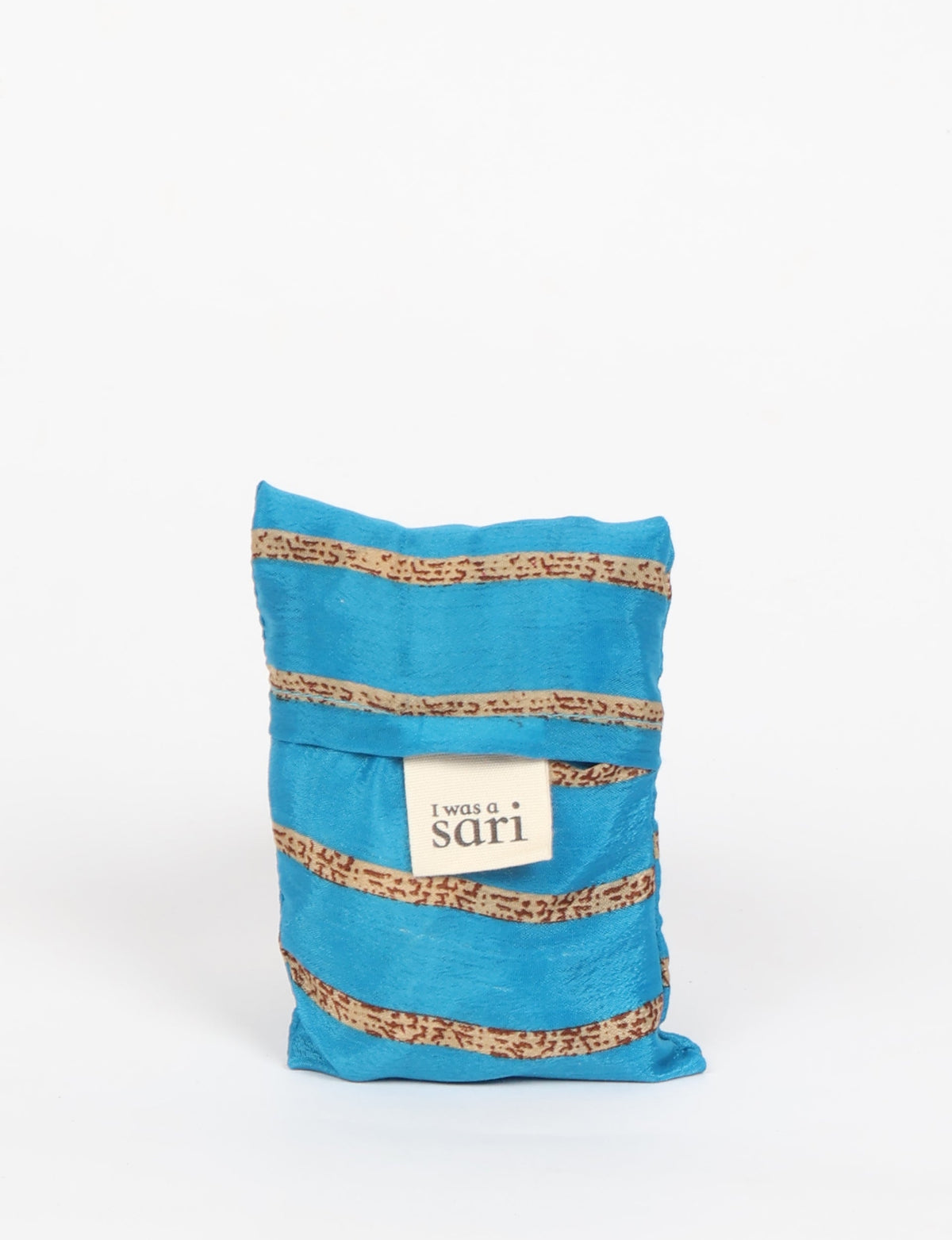 Stay eco-conscious with our Reusable Bag, handmade by Indian artisans from pre-loved saris. Silky and lightweight, this foldaway bag is perfect for your on-the-go lifestyle. Each piece is a unique statement of ethical fashion, embracing sustainability and style.