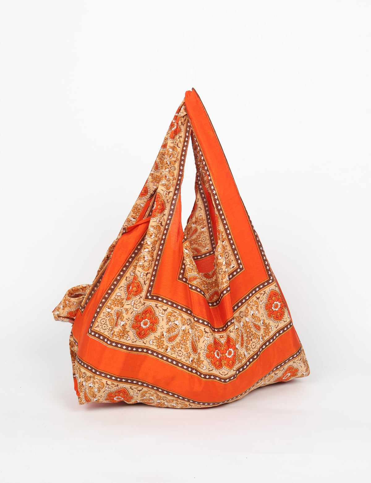 Stay eco-conscious with our Reusable Bag, handmade by Indian artisans from pre-loved saris. Silky and lightweight, this foldaway bag is perfect for your on-the-go lifestyle. Each piece is a unique statement of ethical fashion, embracing sustainability and style.