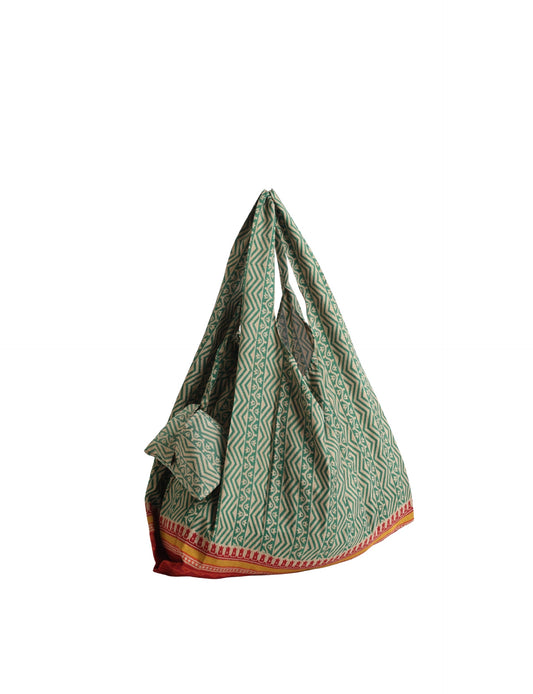 Stay eco-conscious with our Reusable Bag, handmade by Indian artisans from pre-loved saris. Silky and lightweight, this foldaway bag is perfect for your on-the-go lifestyle. Each piece is a unique statement of ethical fashion, embracing sustainability and style.