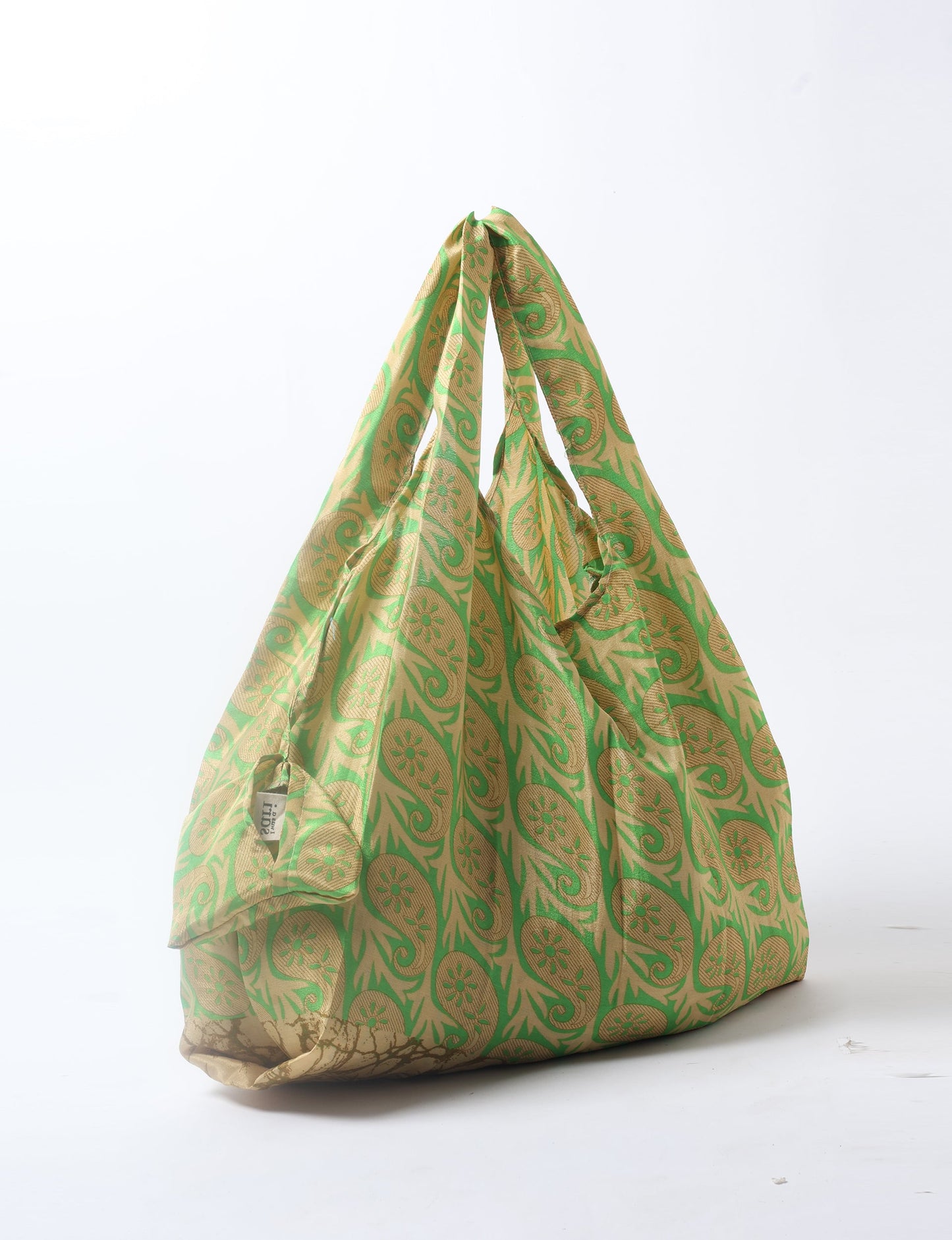 Stay eco-conscious with our Reusable Bag, handmade by Indian artisans from pre-loved saris. Silky and lightweight, this foldaway bag is perfect for your on-the-go lifestyle. Each piece is a unique statement of ethical fashion, embracing sustainability and style.