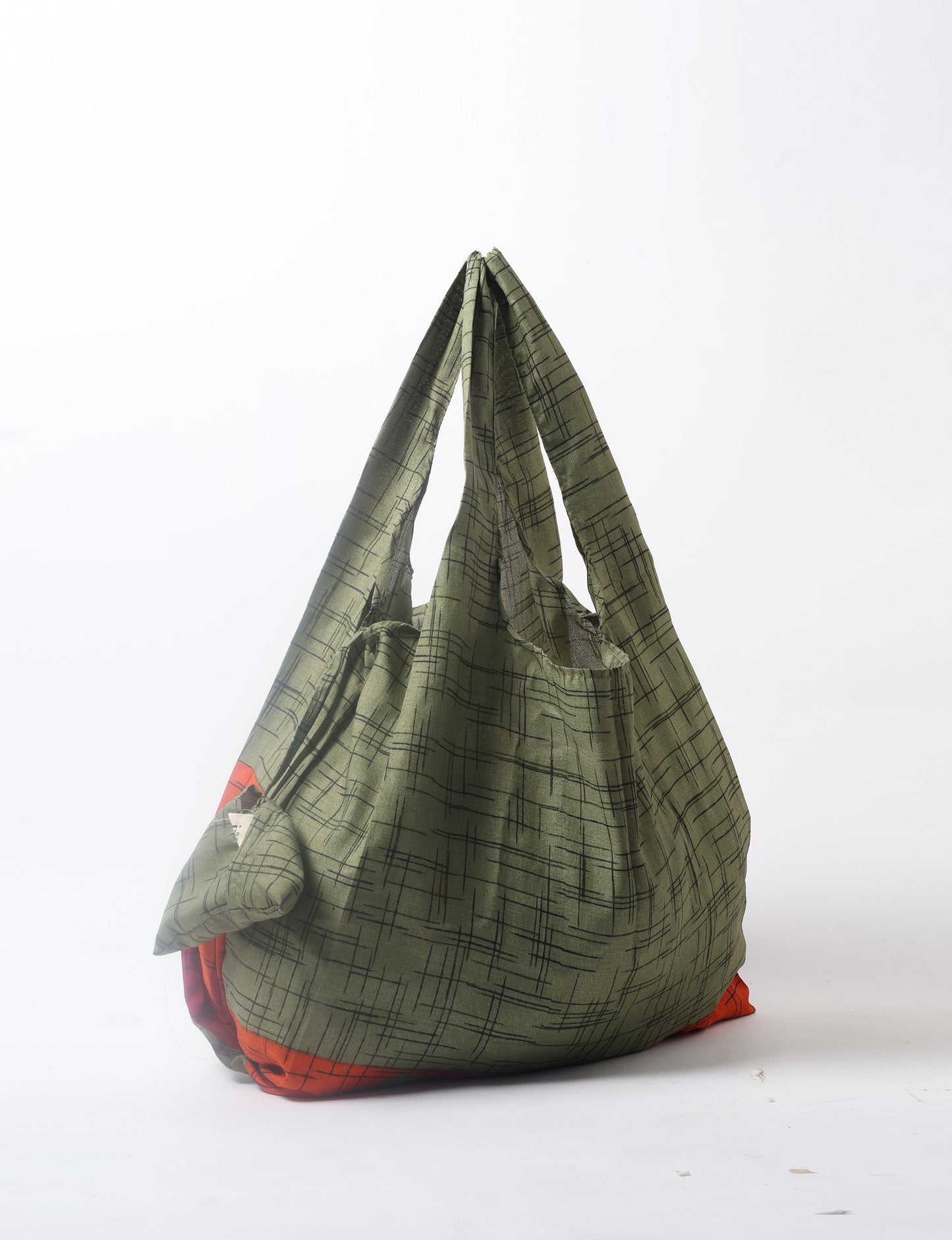 Stay eco-conscious with our Reusable Bag, handmade by Indian artisans from pre-loved saris. Silky and lightweight, this foldaway bag is perfect for your on-the-go lifestyle. Each piece is a unique statement of ethical fashion, embracing sustainability and style.