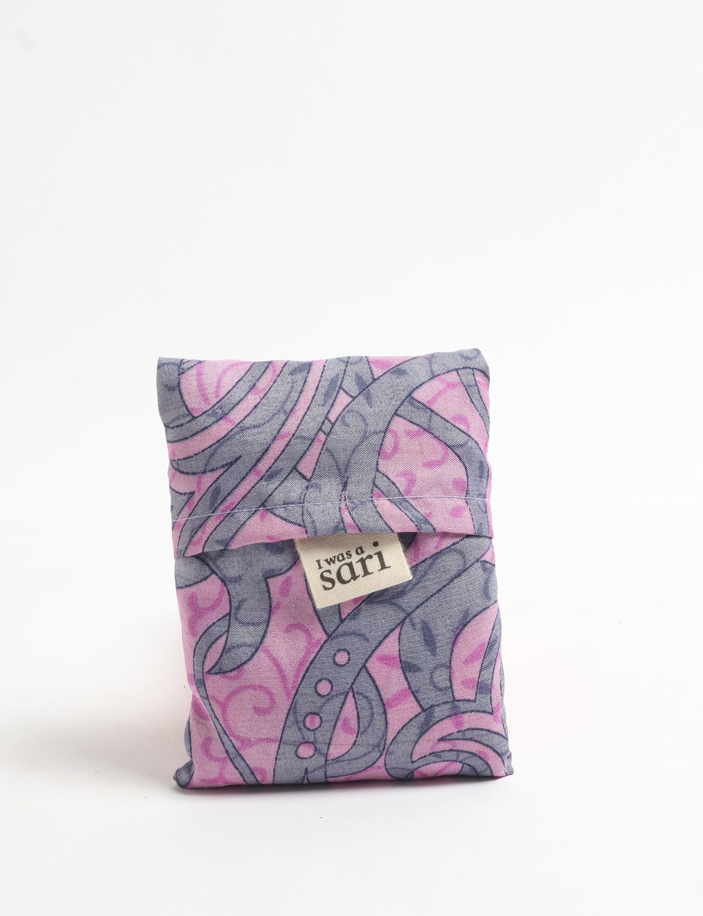 Stay eco-conscious with our Reusable Bag, handmade by Indian artisans from pre-loved saris. Silky and lightweight, this foldaway bag is perfect for your on-the-go lifestyle. Each piece is a unique statement of ethical fashion, embracing sustainability and style.