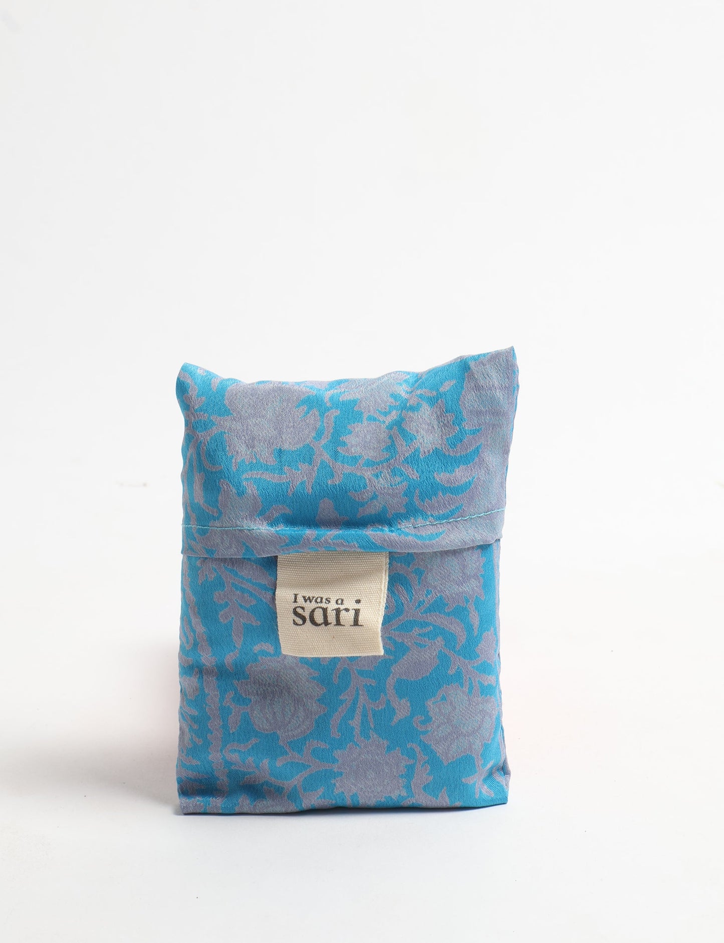 Stay eco-conscious with our Reusable Bag, handmade by Indian artisans from pre-loved saris. Silky and lightweight, this foldaway bag is perfect for your on-the-go lifestyle. Each piece is a unique statement of ethical fashion, embracing sustainability and style.