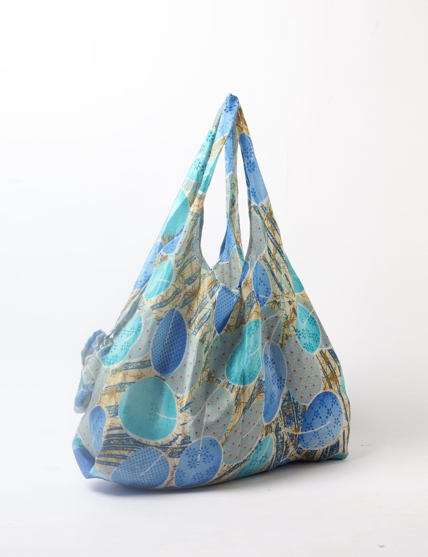 Stay eco-conscious with our Reusable Bag, handmade by Indian artisans from pre-loved saris. Silky and lightweight, this foldaway bag is perfect for your on-the-go lifestyle. Each piece is a unique statement of ethical fashion, embracing sustainability and style.