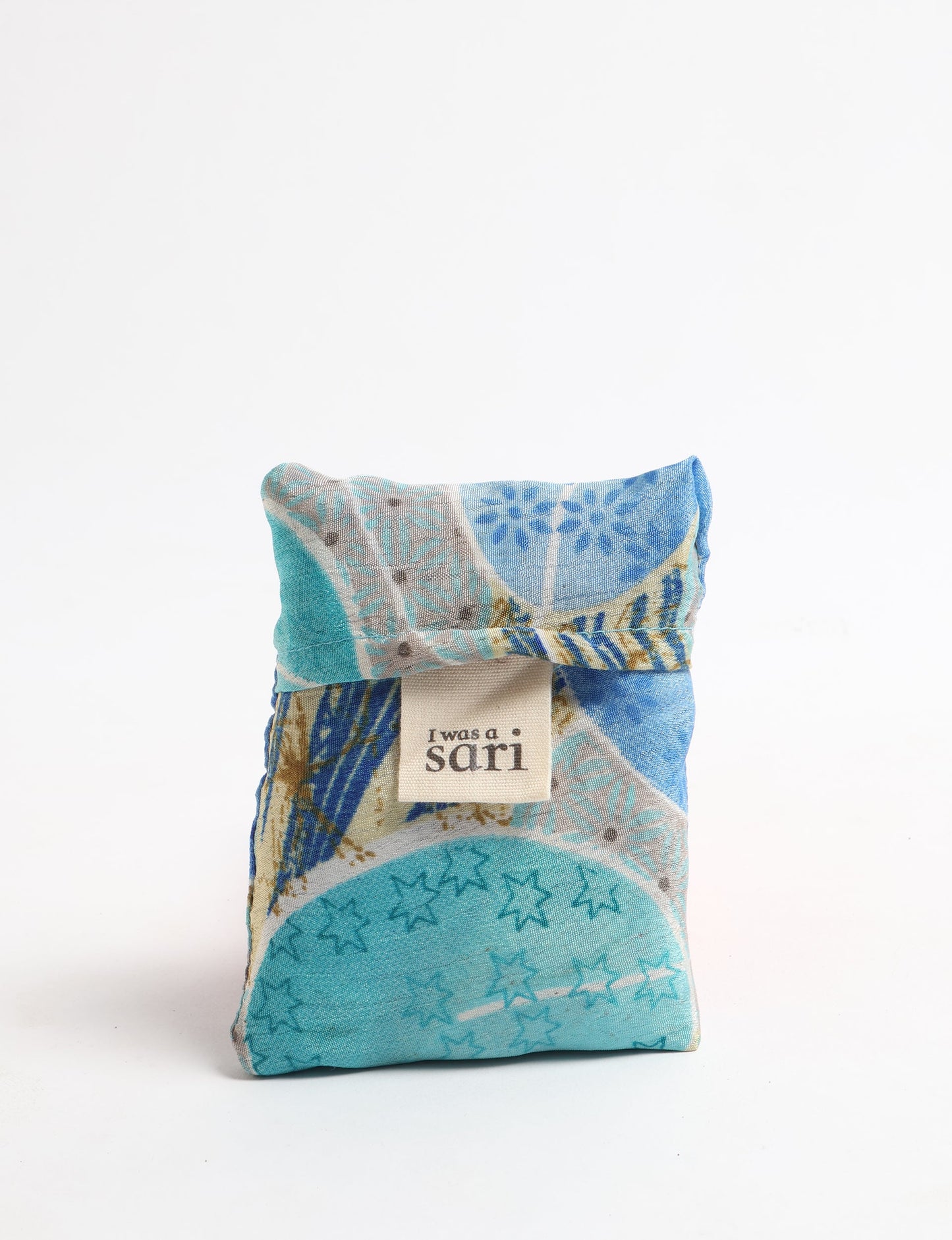 Stay eco-conscious with our Reusable Bag, handmade by Indian artisans from pre-loved saris. Silky and lightweight, this foldaway bag is perfect for your on-the-go lifestyle. Each piece is a unique statement of ethical fashion, embracing sustainability and style.