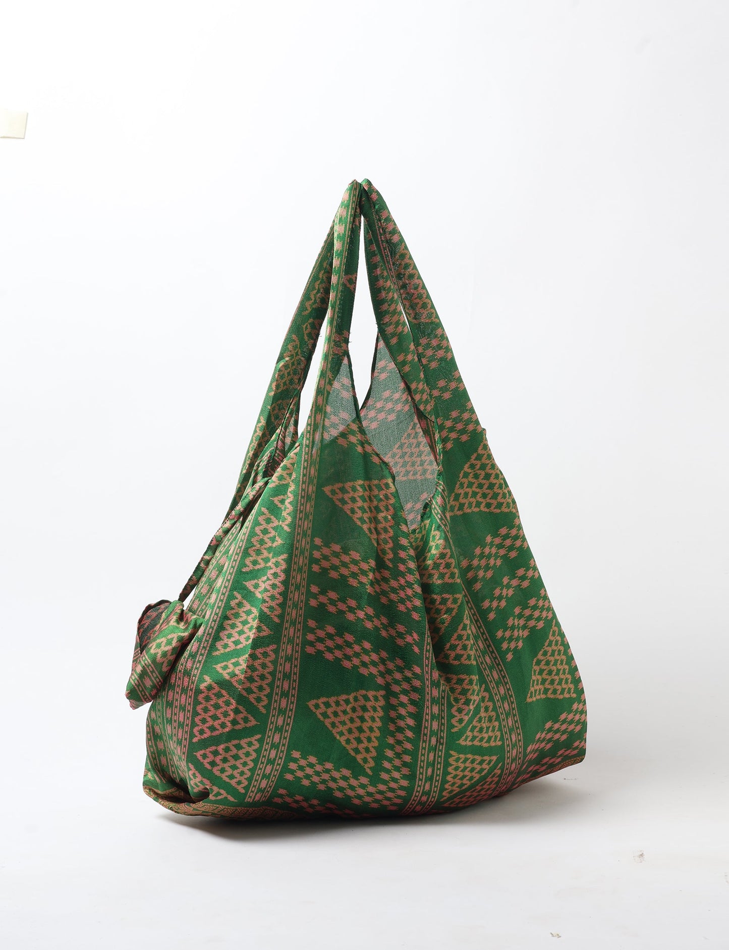 Stay eco-conscious with our Reusable Bag, handmade by Indian artisans from pre-loved saris. Silky and lightweight, this foldaway bag is perfect for your on-the-go lifestyle. Each piece is a unique statement of ethical fashion, embracing sustainability and style.