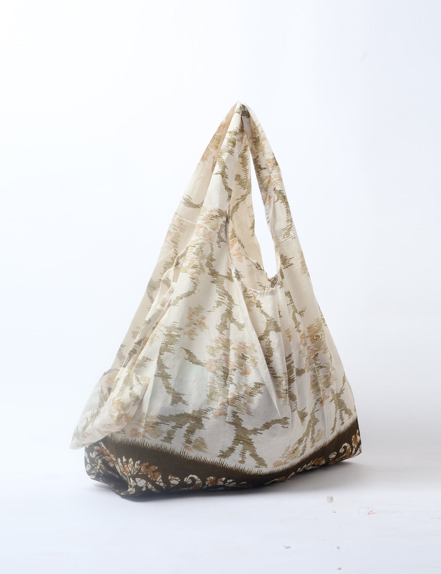 Stay eco-conscious with our Reusable Bag, handmade by Indian artisans from pre-loved saris. Silky and lightweight, this foldaway bag is perfect for your on-the-go lifestyle. Each piece is a unique statement of ethical fashion, embracing sustainability and style.