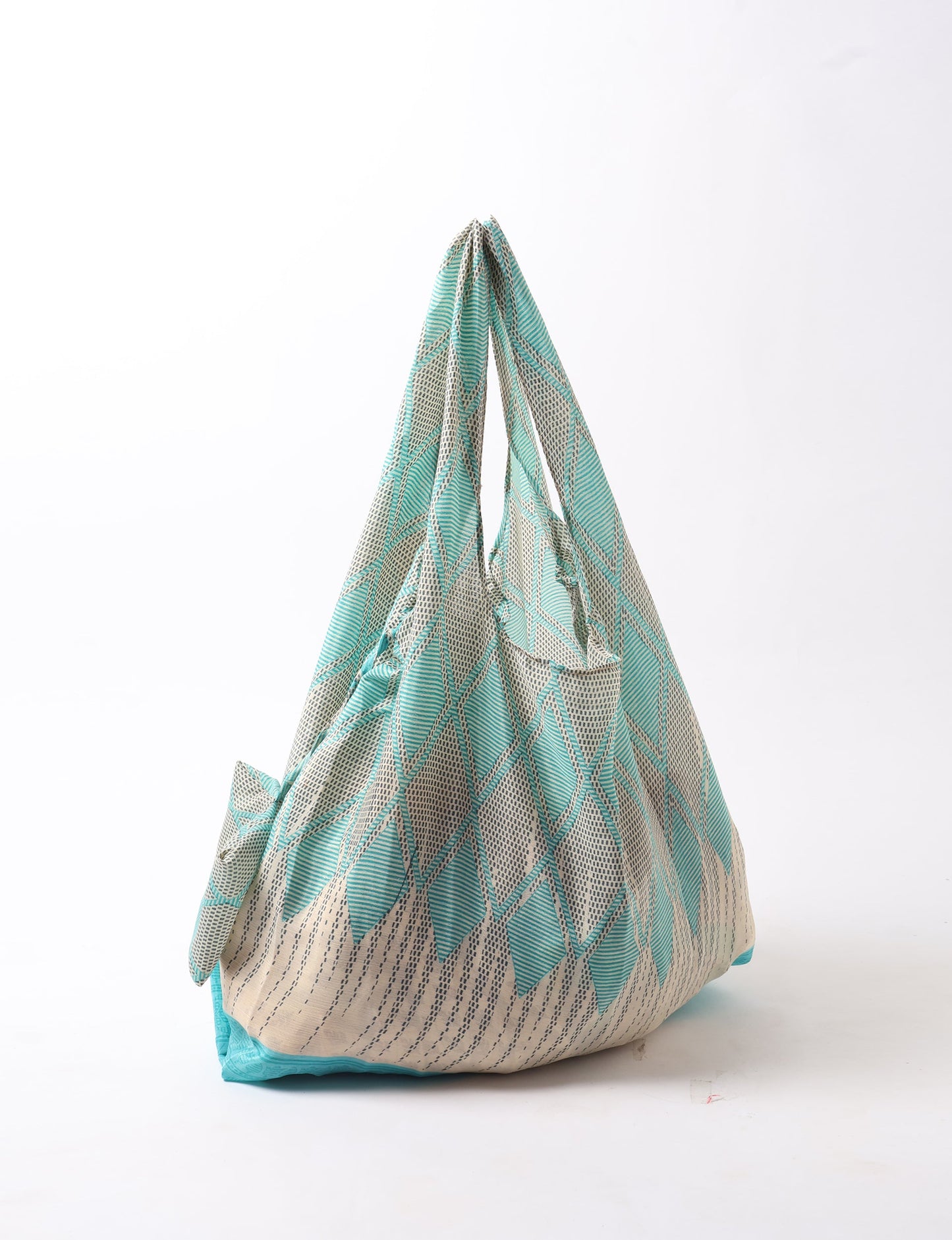 Stay eco-conscious with our Reusable Bag, handmade by Indian artisans from pre-loved saris. Silky and lightweight, this foldaway bag is perfect for your on-the-go lifestyle. Each piece is a unique statement of ethical fashion, embracing sustainability and style.