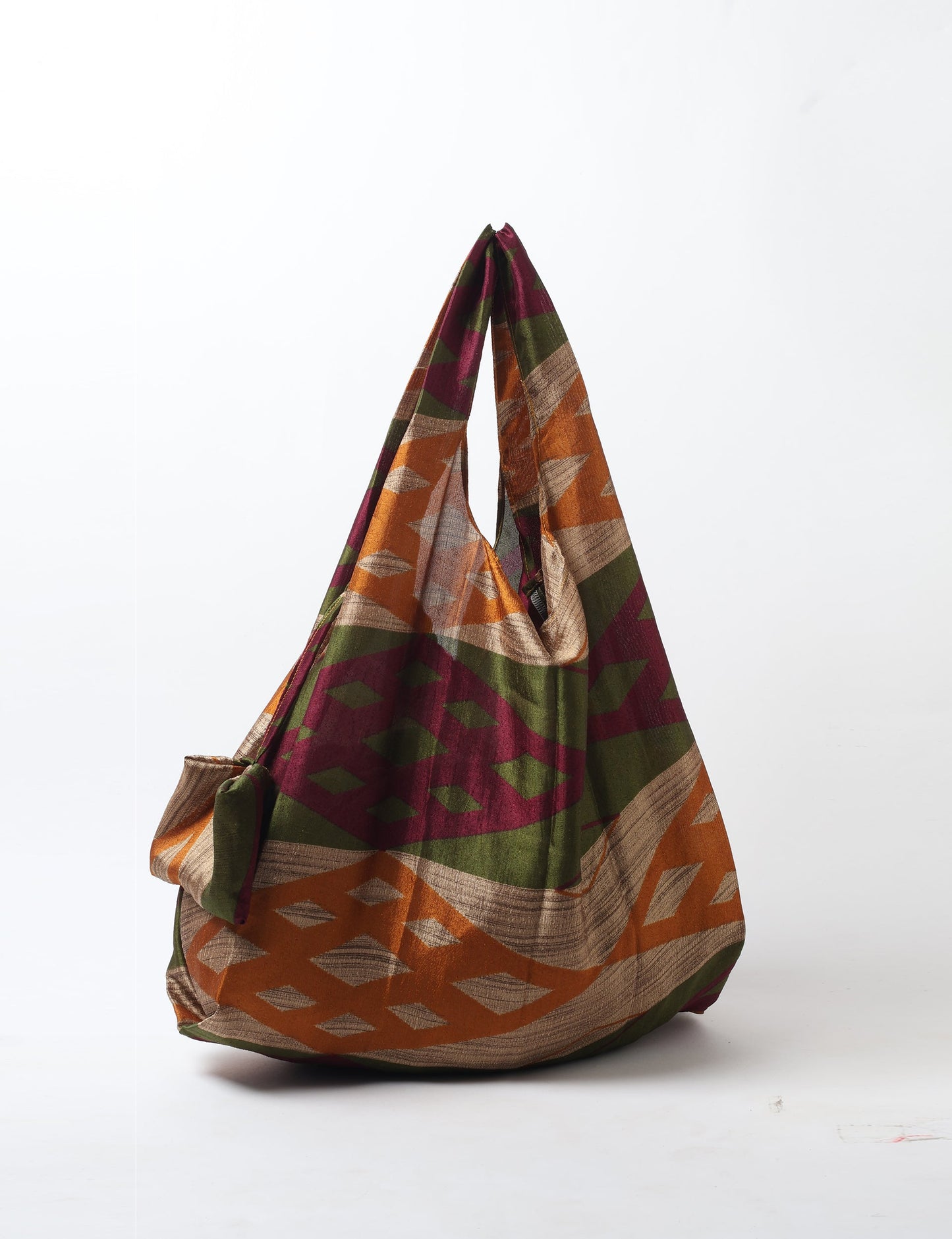 Stay eco-conscious with our Reusable Bag, handmade by Indian artisans from pre-loved saris. Silky and lightweight, this foldaway bag is perfect for your on-the-go lifestyle. Each piece is a unique statement of ethical fashion, embracing sustainability and style.