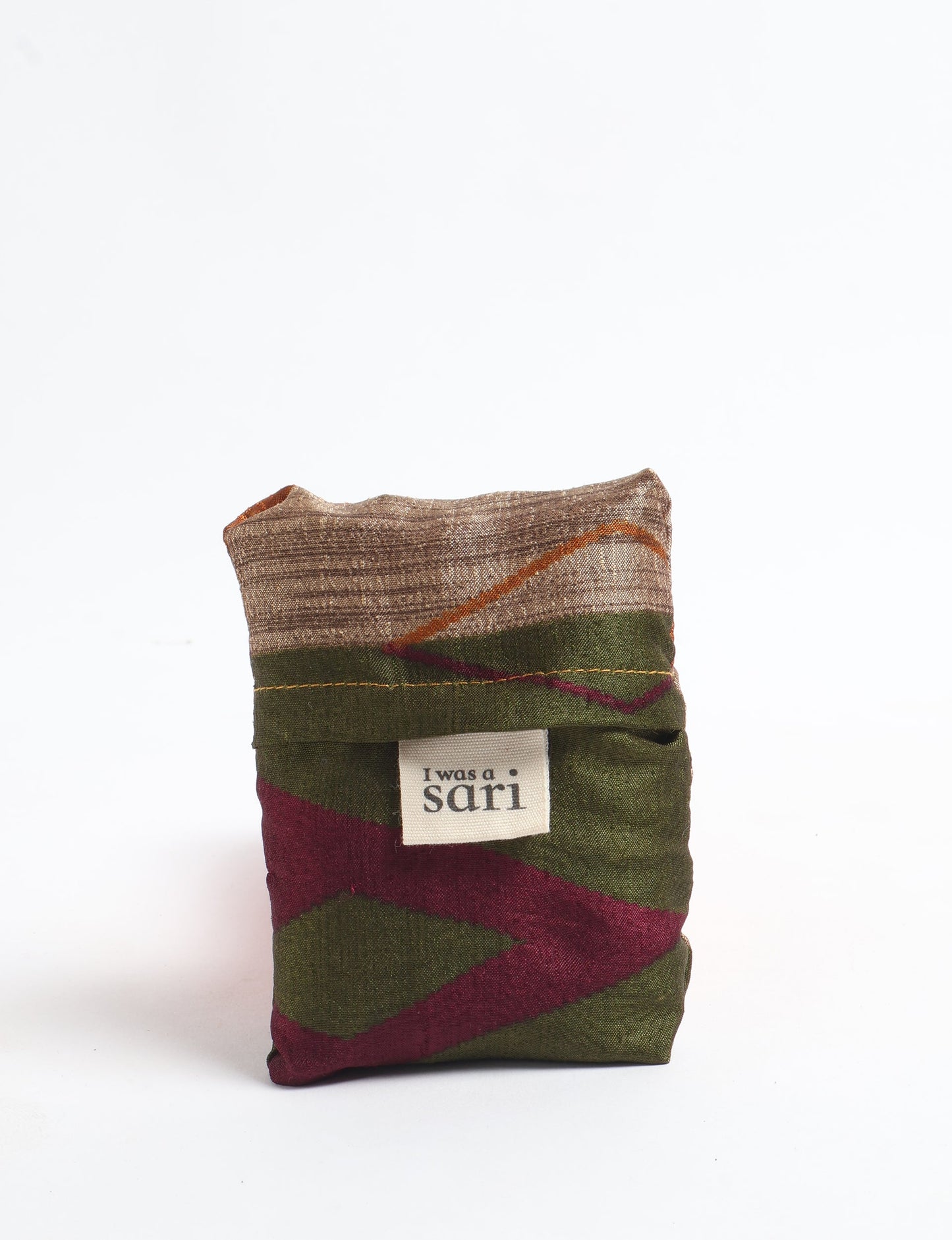 Stay eco-conscious with our Reusable Bag, handmade by Indian artisans from pre-loved saris. Silky and lightweight, this foldaway bag is perfect for your on-the-go lifestyle. Each piece is a unique statement of ethical fashion, embracing sustainability and style.