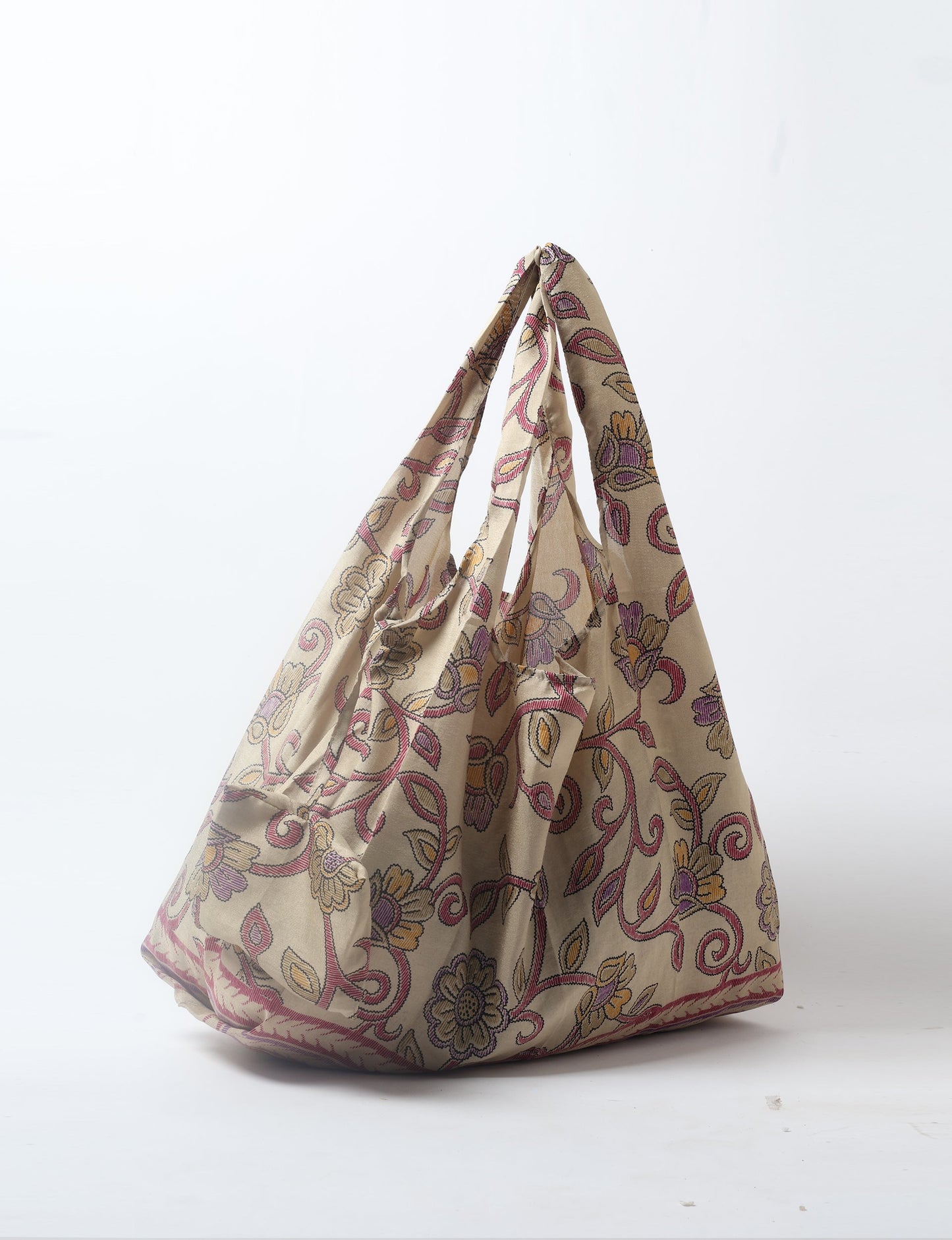 Stay eco-conscious with our Reusable Bag, handmade by Indian artisans from pre-loved saris. Silky and lightweight, this foldaway bag is perfect for your on-the-go lifestyle. Each piece is a unique statement of ethical fashion, embracing sustainability and style.