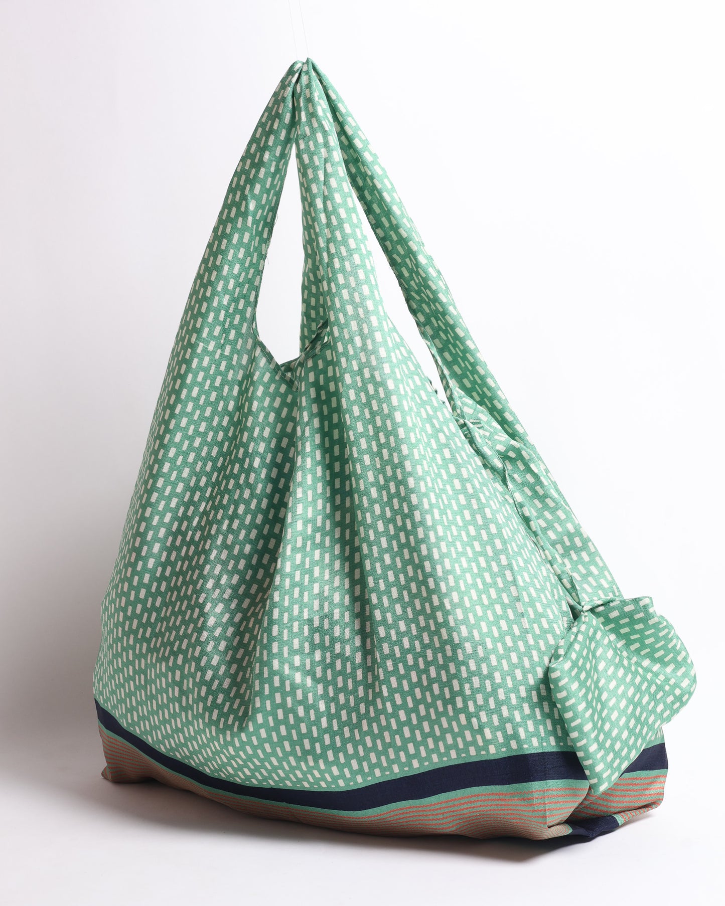 Stay eco-conscious with our Reusable Bag, handmade by Indian artisans from pre-loved saris. Silky and lightweight, this foldaway bag is perfect for your on-the-go lifestyle. Each piece is a unique statement of ethical fashion, embracing sustainability and style.