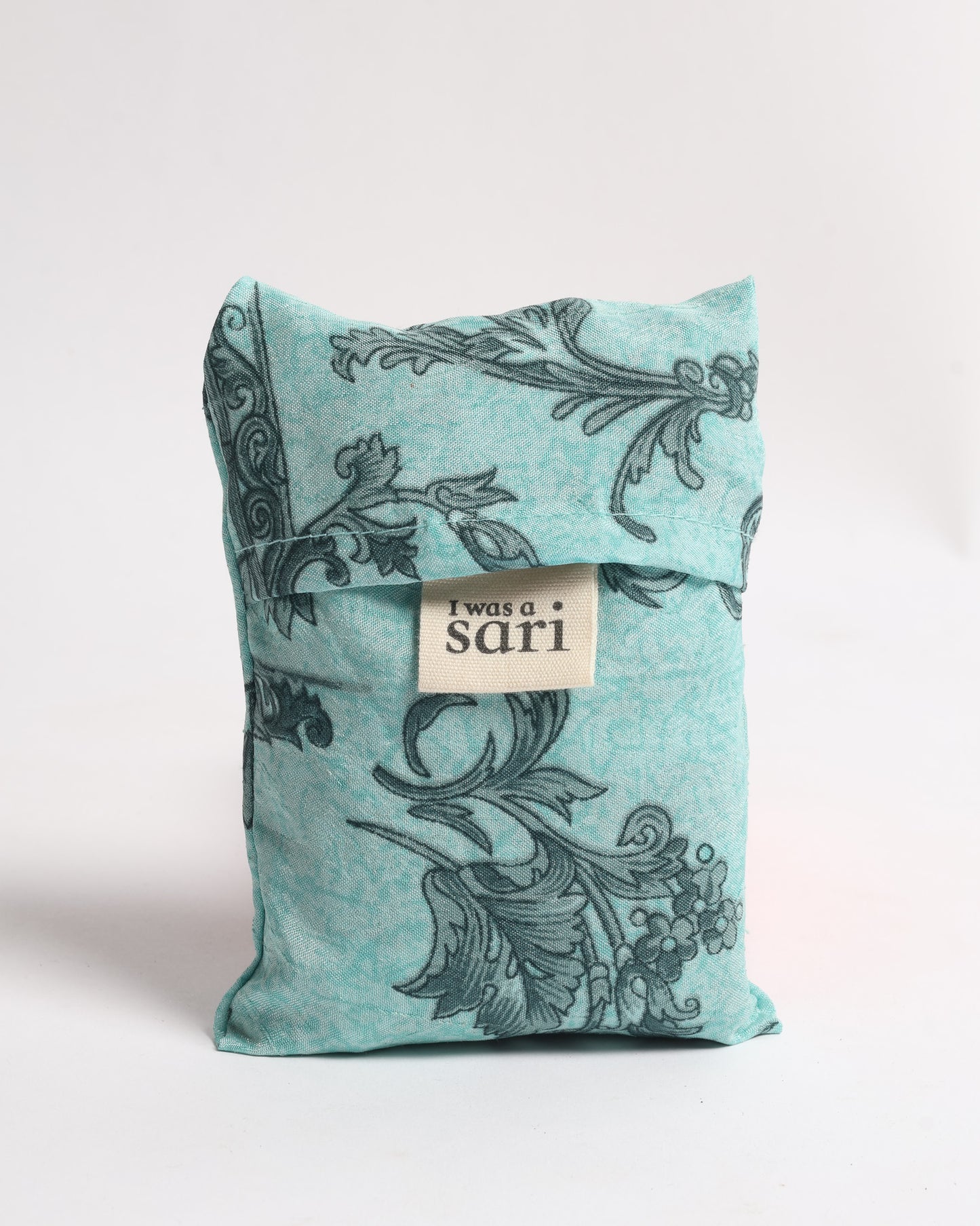 Stay eco-conscious with our Reusable Bag, handmade by Indian artisans from pre-loved saris. Silky and lightweight, this foldaway bag is perfect for your on-the-go lifestyle. Each piece is a unique statement of ethical fashion, embracing sustainability and style.