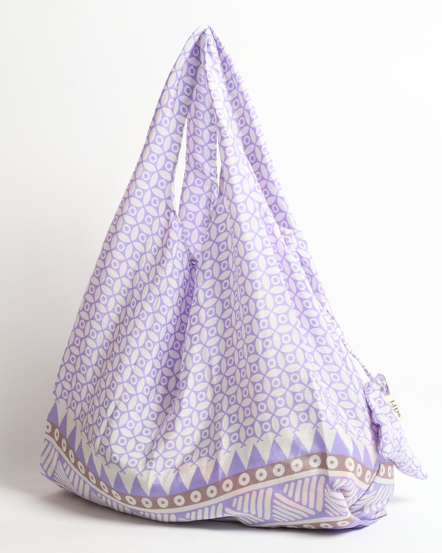 Stay eco-conscious with our Reusable Bag, handmade by Indian artisans from pre-loved saris. Silky and lightweight, this foldaway bag is perfect for your on-the-go lifestyle. Each piece is a unique statement of ethical fashion, embracing sustainability and style.