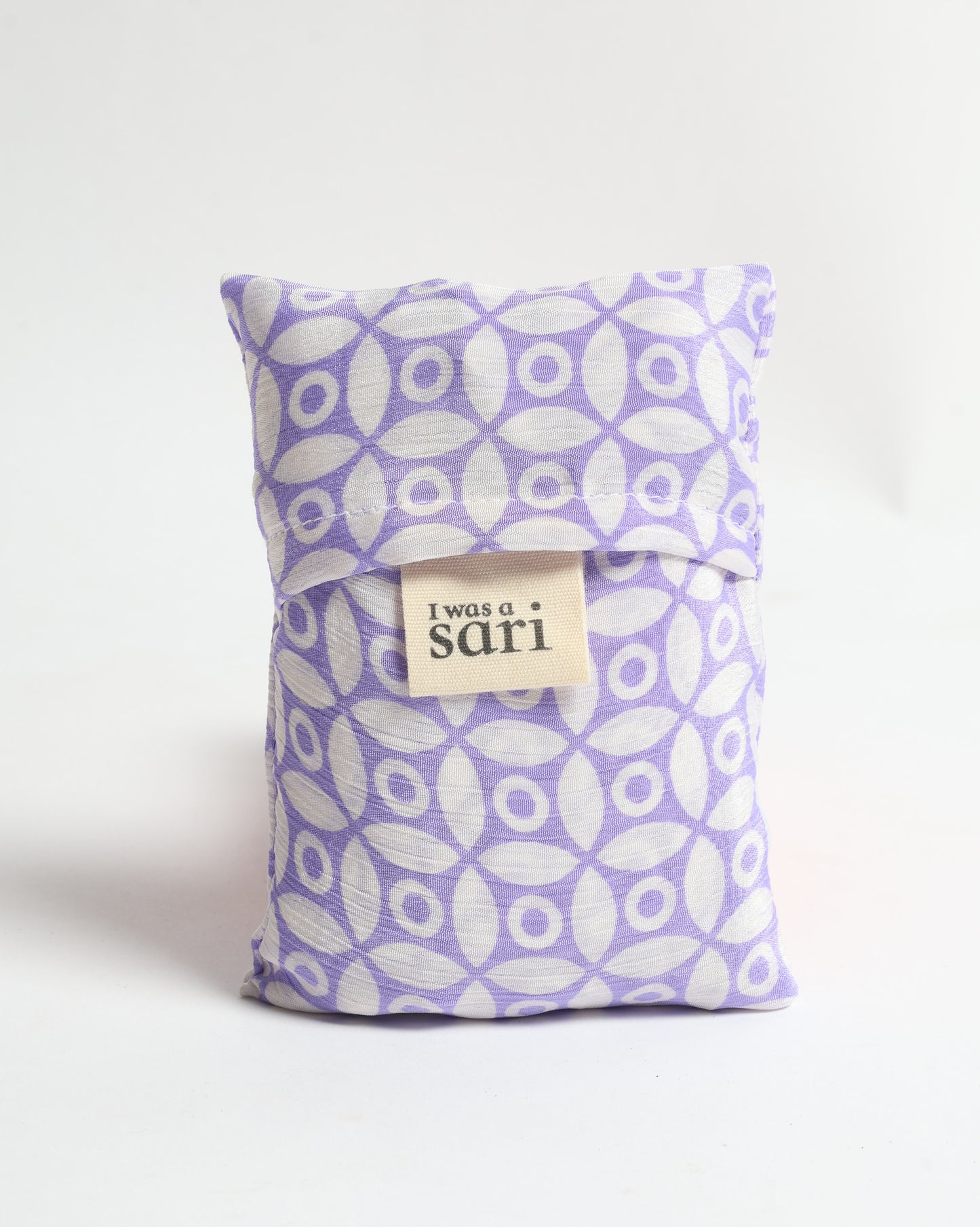 Stay eco-conscious with our Reusable Bag, handmade by Indian artisans from pre-loved saris. Silky and lightweight, this foldaway bag is perfect for your on-the-go lifestyle. Each piece is a unique statement of ethical fashion, embracing sustainability and style.