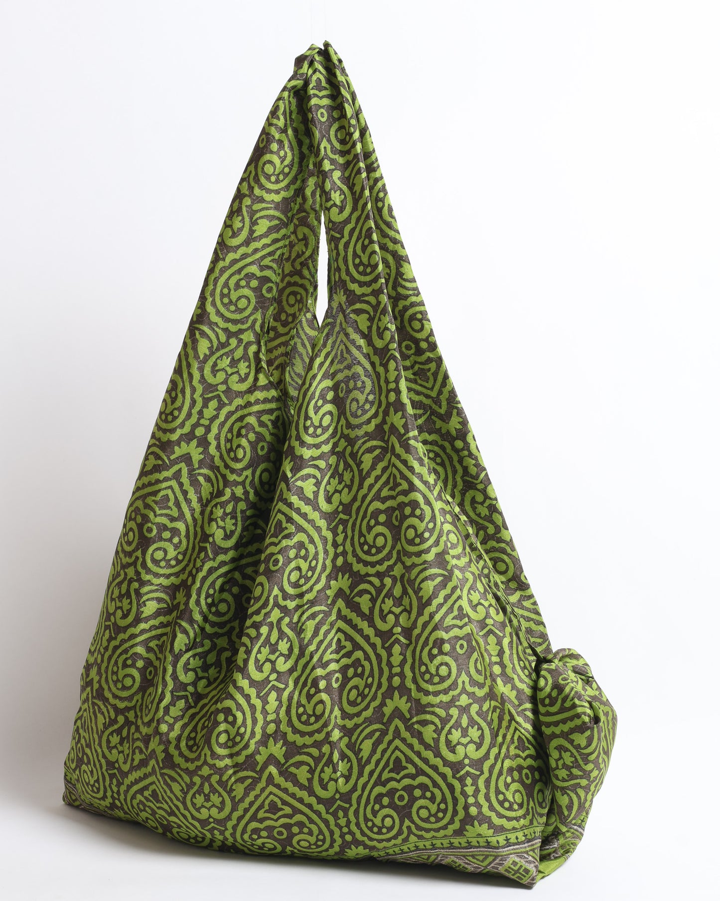 Stay eco-conscious with our Reusable Bag, handmade by Indian artisans from pre-loved saris. Silky and lightweight, this foldaway bag is perfect for your on-the-go lifestyle. Each piece is a unique statement of ethical fashion, embracing sustainability and style.