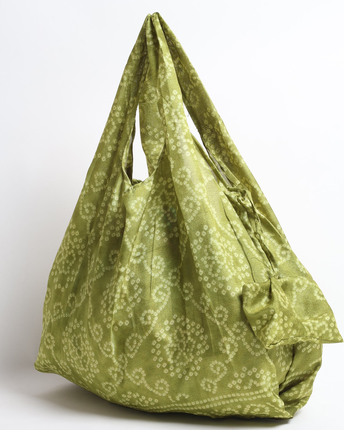 Stay eco-conscious with our Reusable Bag, handmade by Indian artisans from pre-loved saris. Silky and lightweight, this foldaway bag is perfect for your on-the-go lifestyle. Each piece is a unique statement of ethical fashion, embracing sustainability and style.