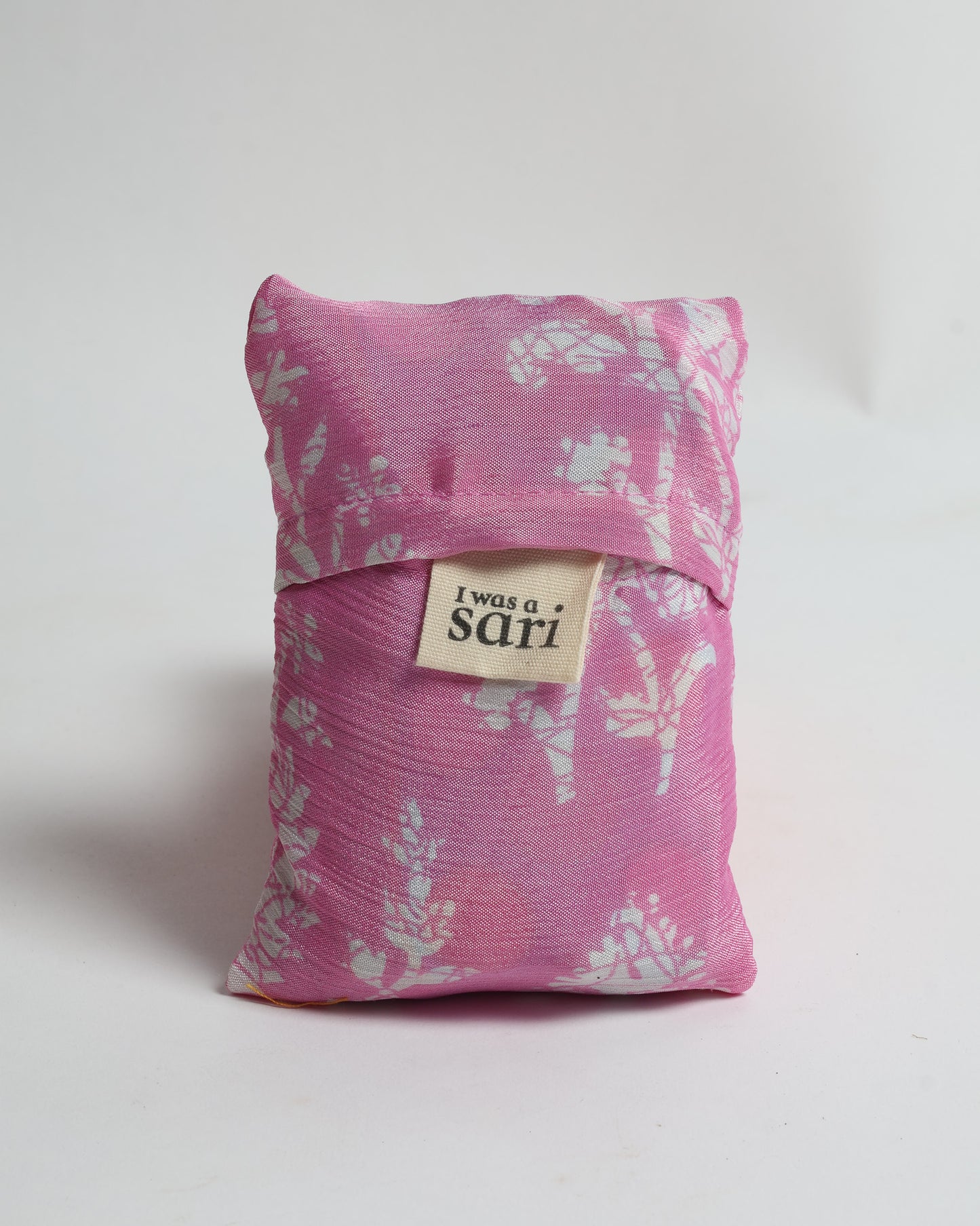 Stay eco-conscious with our Reusable Bag, handmade by Indian artisans from pre-loved saris. Silky and lightweight, this foldaway bag is perfect for your on-the-go lifestyle. Each piece is a unique statement of ethical fashion, embracing sustainability and style.