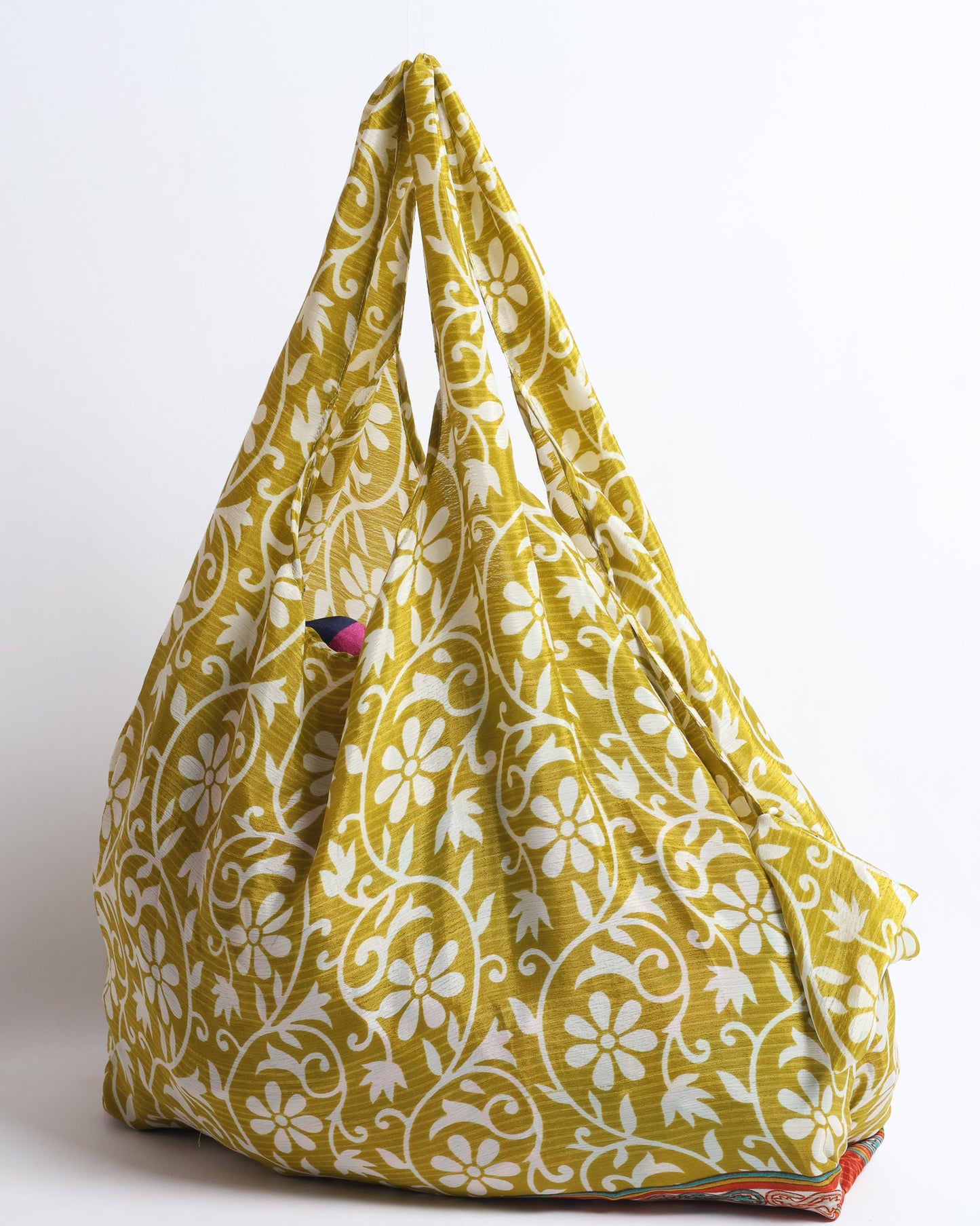 Stay eco-conscious with our Reusable Bag, handmade by Indian artisans from pre-loved saris. Silky and lightweight, this foldaway bag is perfect for your on-the-go lifestyle. Each piece is a unique statement of ethical fashion, embracing sustainability and style.