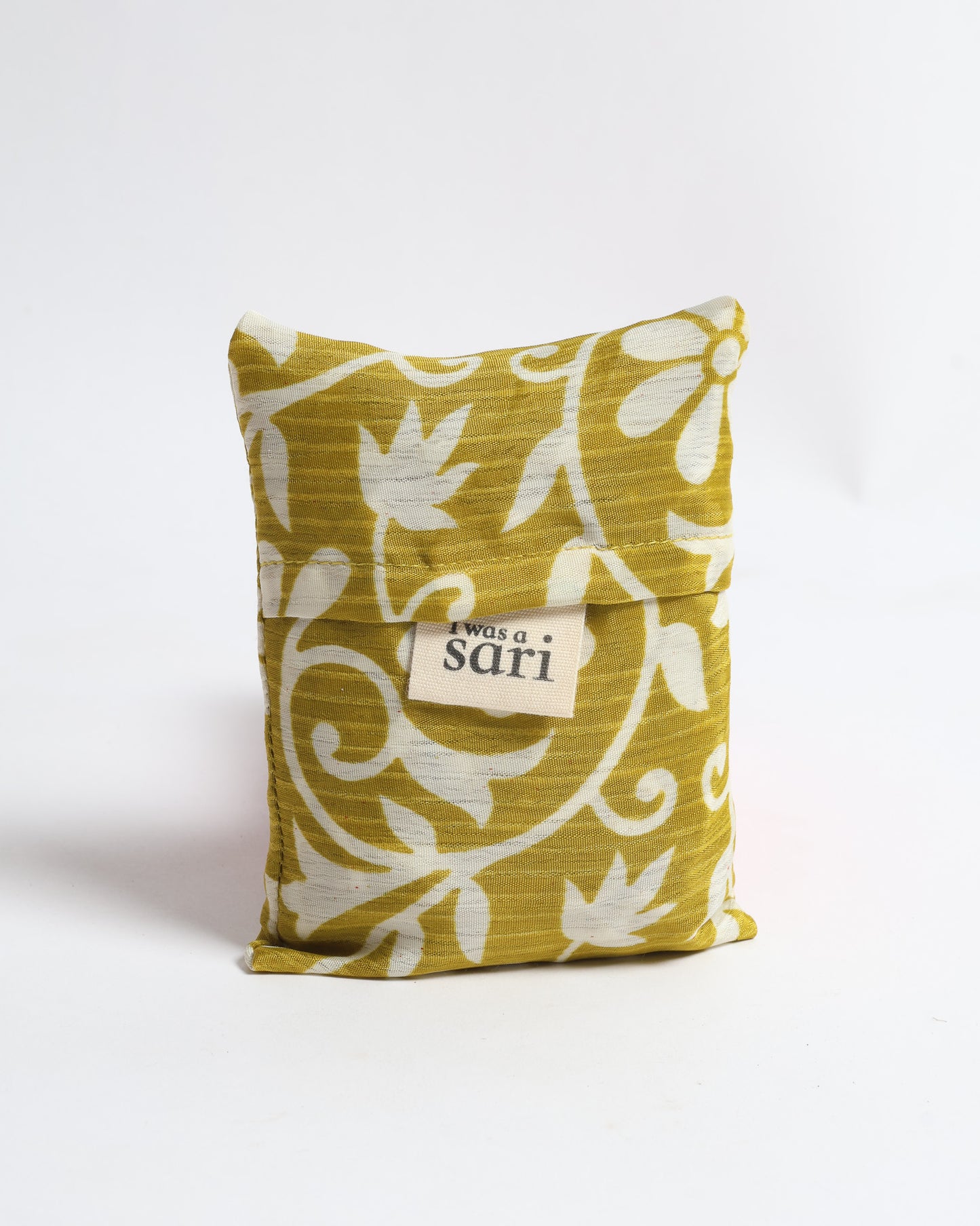 Stay eco-conscious with our Reusable Bag, handmade by Indian artisans from pre-loved saris. Silky and lightweight, this foldaway bag is perfect for your on-the-go lifestyle. Each piece is a unique statement of ethical fashion, embracing sustainability and style.