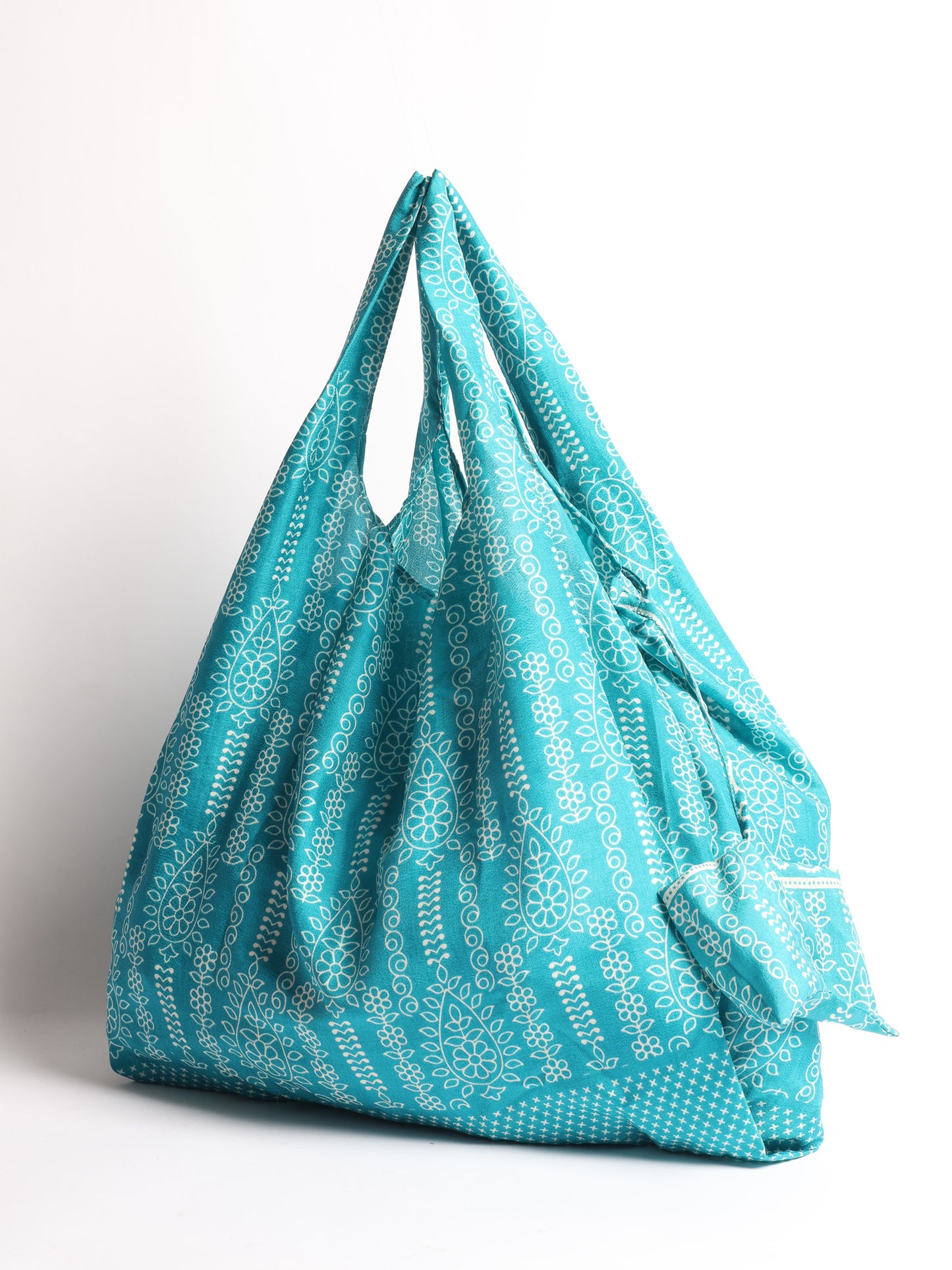 Stay eco-conscious with our Reusable Bag, handmade by Indian artisans from pre-loved saris. Silky and lightweight, this foldaway bag is perfect for your on-the-go lifestyle. Each piece is a unique statement of ethical fashion, embracing sustainability and style.