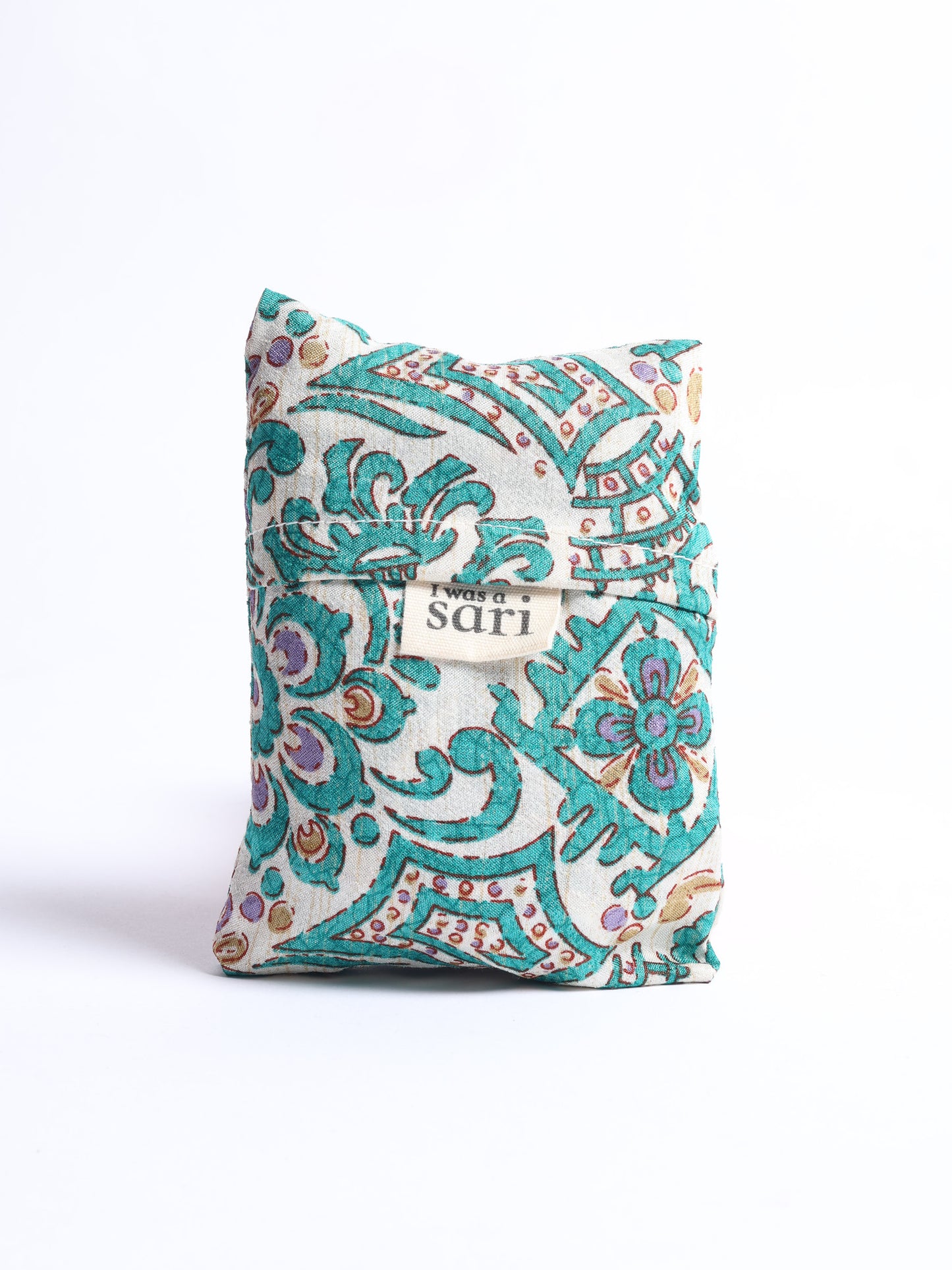 Stay eco-conscious with our Reusable Bag, handmade by Indian artisans from pre-loved saris. Silky and lightweight, this foldaway bag is perfect for your on-the-go lifestyle. Each piece is a unique statement of ethical fashion, embracing sustainability and style.