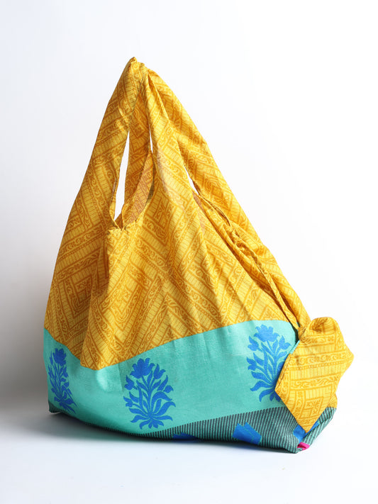 Stay eco-conscious with our Reusable Bag, handmade by Indian artisans from pre-loved saris. Silky and lightweight, this foldaway bag is perfect for your on-the-go lifestyle. Each piece is a unique statement of ethical fashion, embracing sustainability and style.