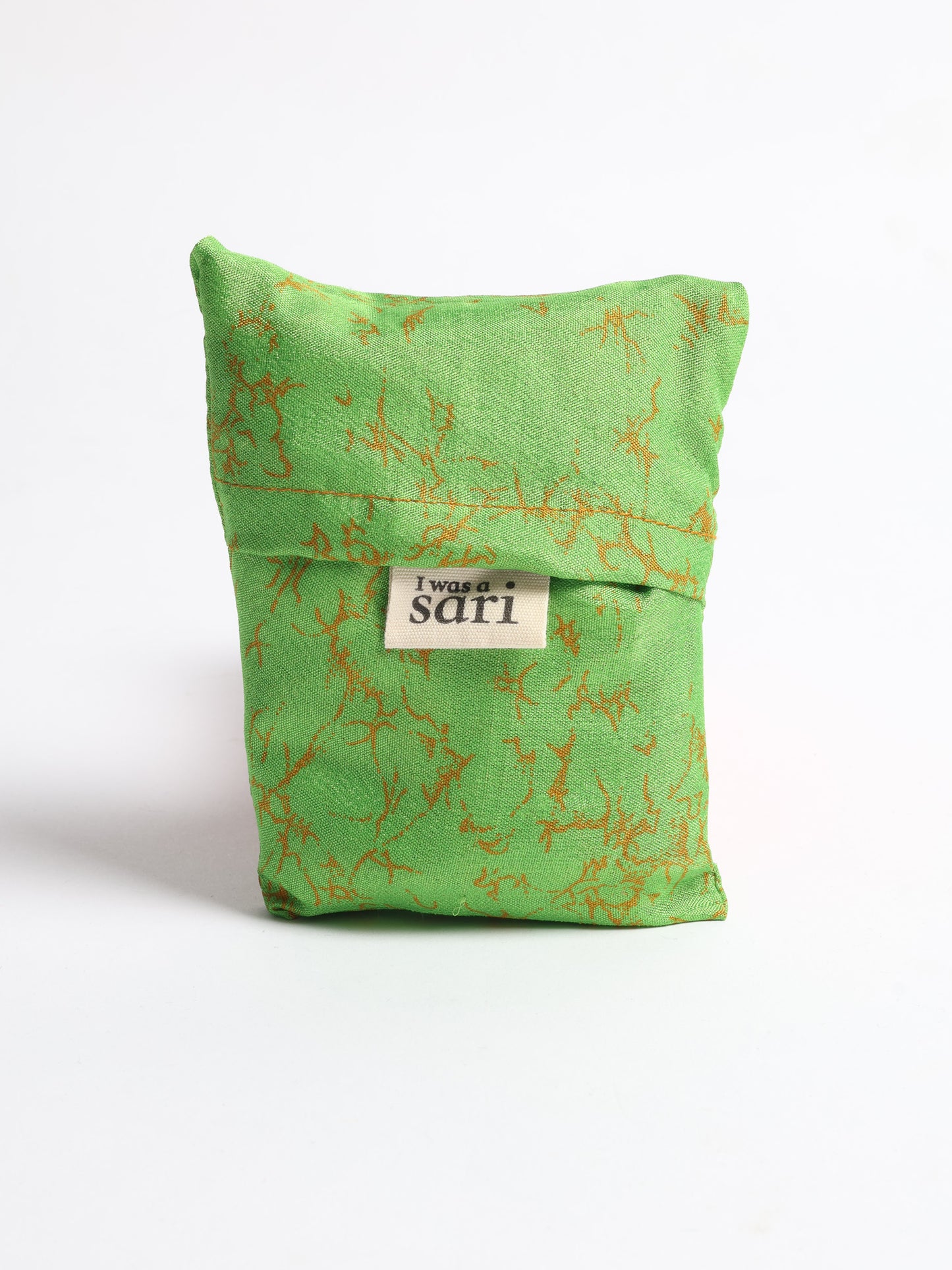 Stay eco-conscious with our Reusable Bag, handmade by Indian artisans from pre-loved saris. Silky and lightweight, this foldaway bag is perfect for your on-the-go lifestyle. Each piece is a unique statement of ethical fashion, embracing sustainability and style.