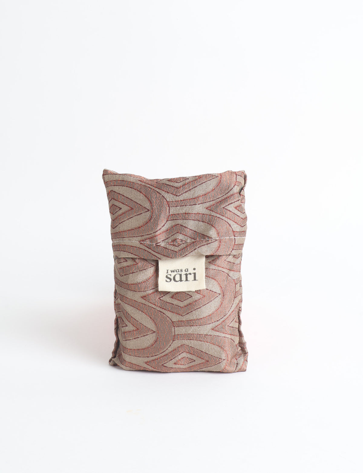 Blue reusable bag with multicolor tropical floral pattern folded with "I was a sari" label visible on front