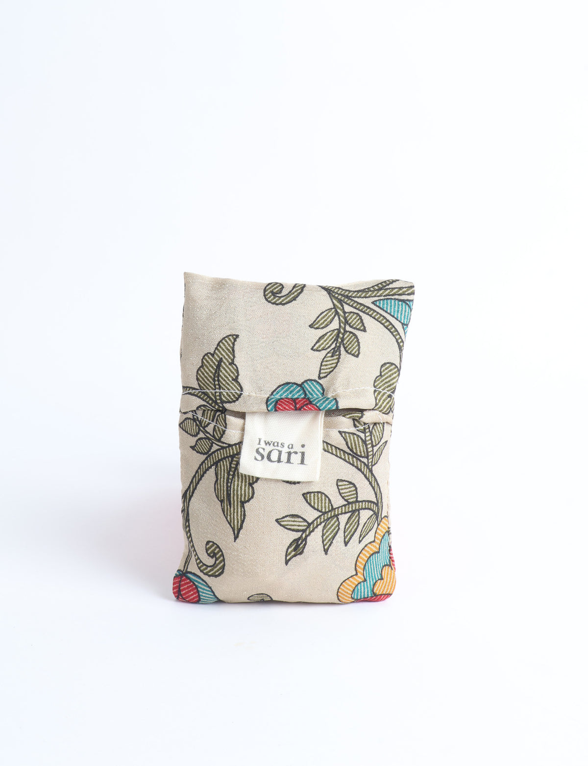 Blue reusable bag with multicolor tropical floral pattern folded with "I was a sari" label visible on front