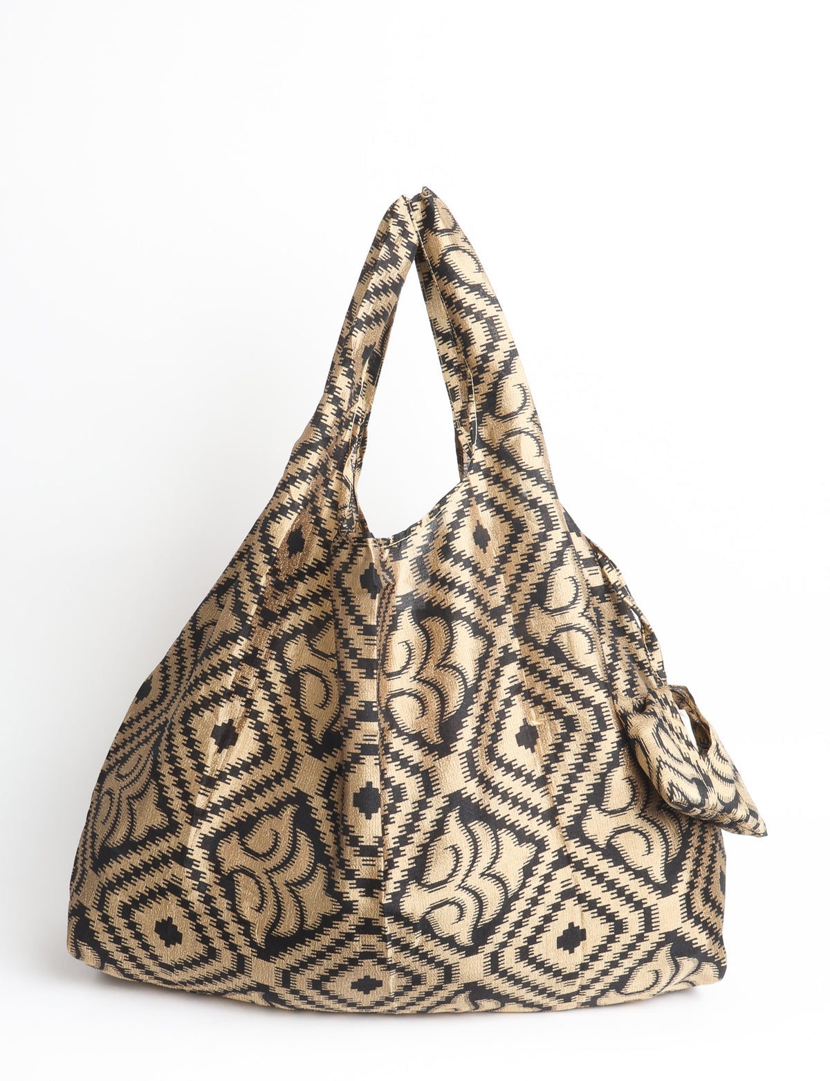 Blue reusable bag with multicolor tropical floral pattern folded with "I was a sari" label visible on front
