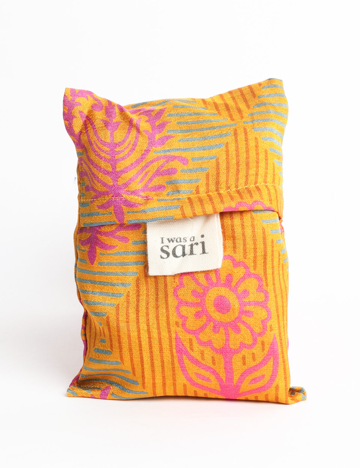 Blue reusable bag with tropical floral pattern in pink, yellow, and green, shown hanging with handles visible